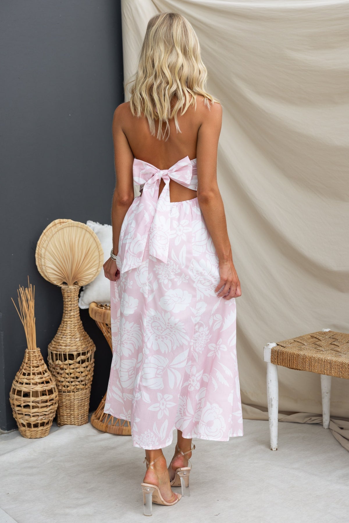 Back view of a floral print Corio midi dress with a tie halter neckline and elastic detailing, perfect for summer.