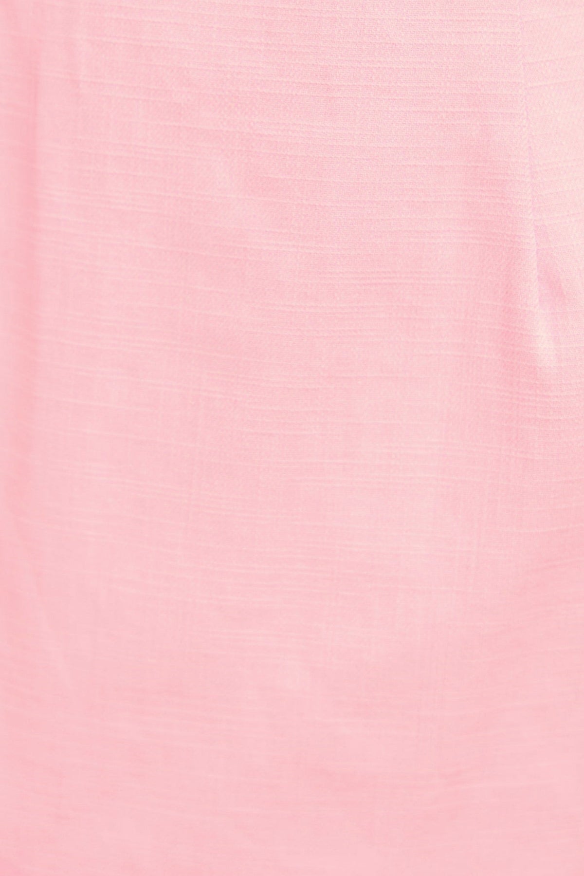 Close-up of soft pink fabric texture, showcasing a delicate, smooth cotton look for the Mirai Maxi Dress.