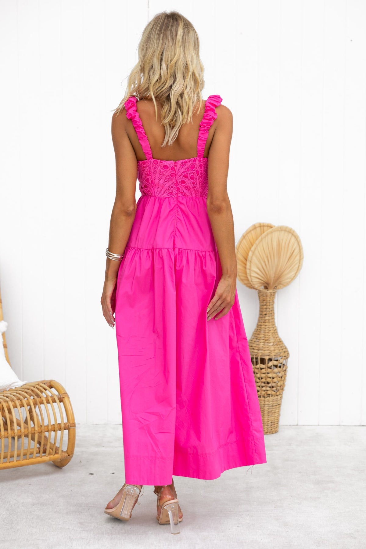 Stylish woman in a pink Neisha Maxi Dress showcasing lace detailing and elastic straps.
