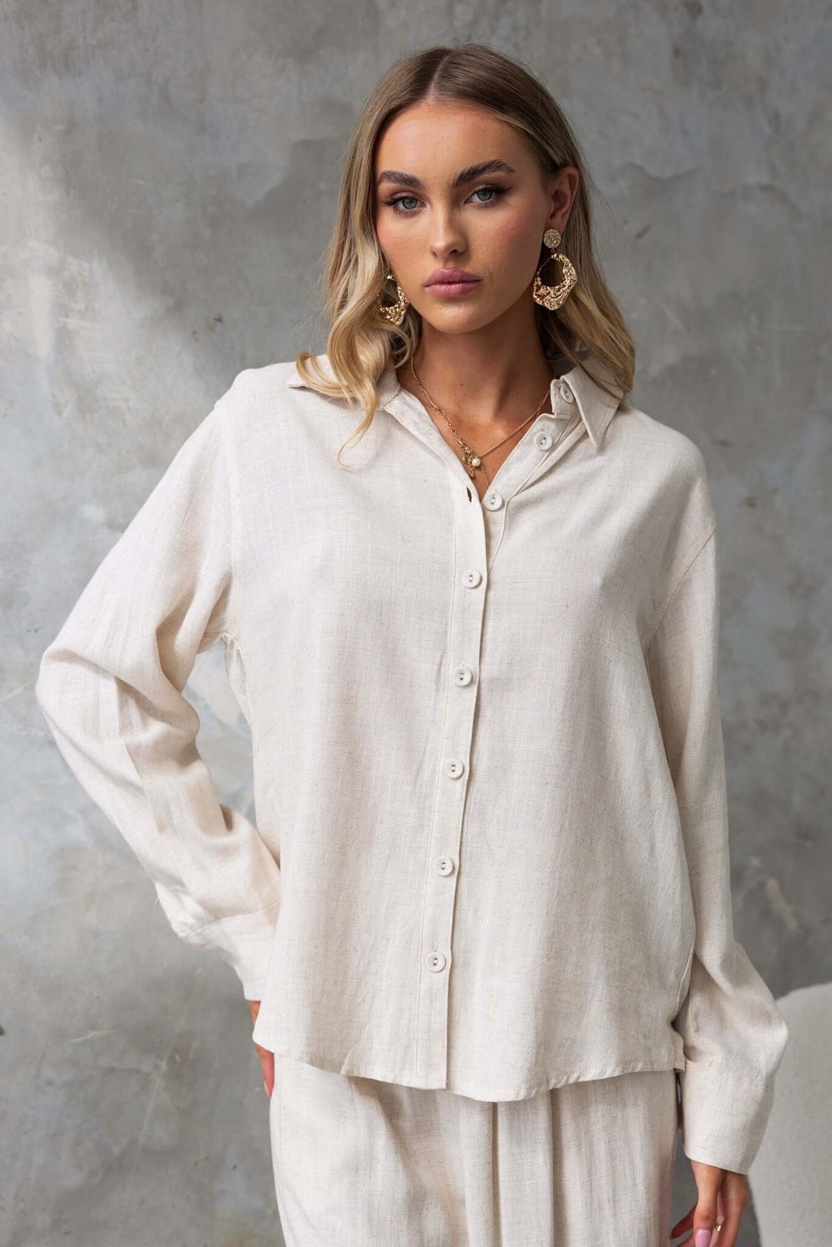 Model wearing Umali Shirt, a relaxed linen button-up in a light, neutral tone, perfect for summer outfits.