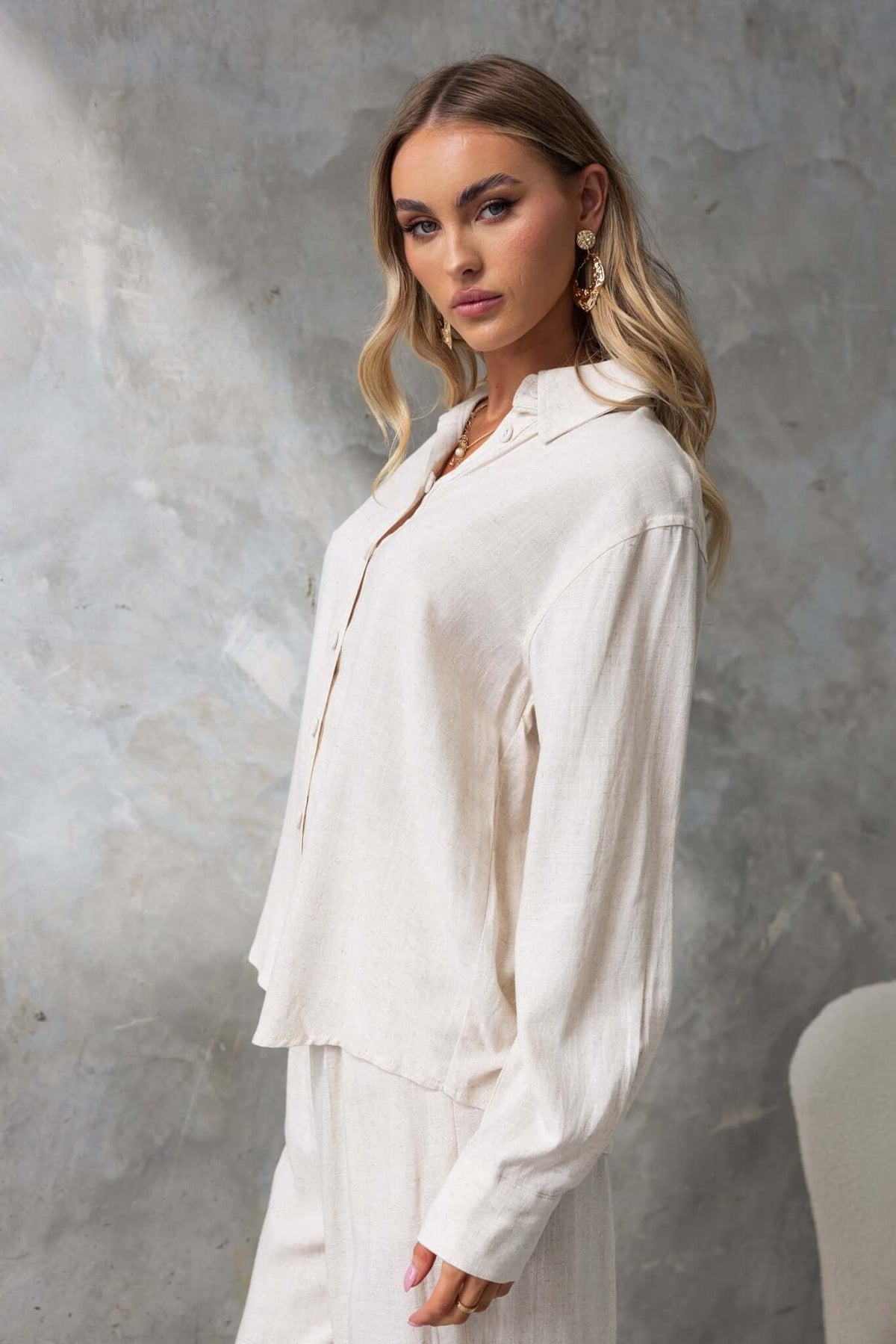 Model showcasing the Umali Shirt in a light gray linen look, featuring a button-up front and relaxed fit.
