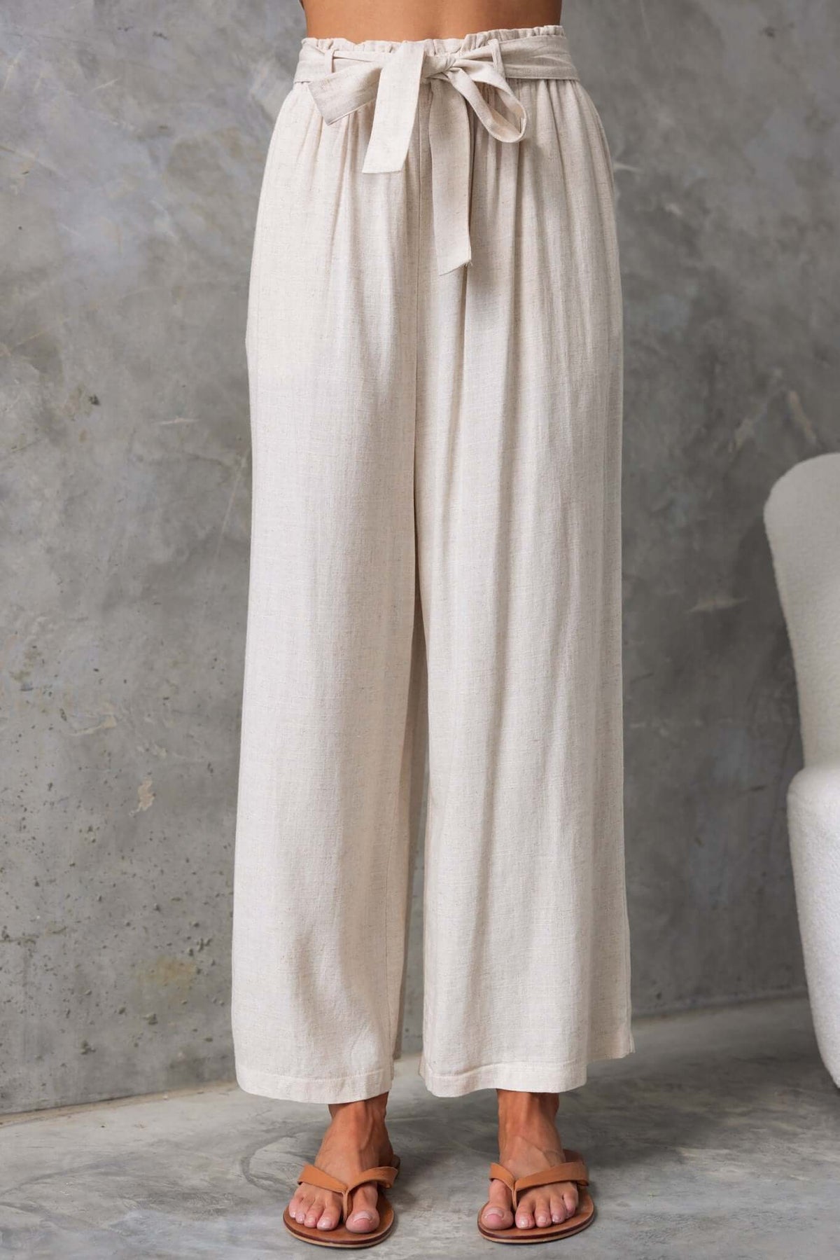 Umali Pants in light beige, featuring a mid-high waist, elastic waistband, and removable tie, perfect for summer style.