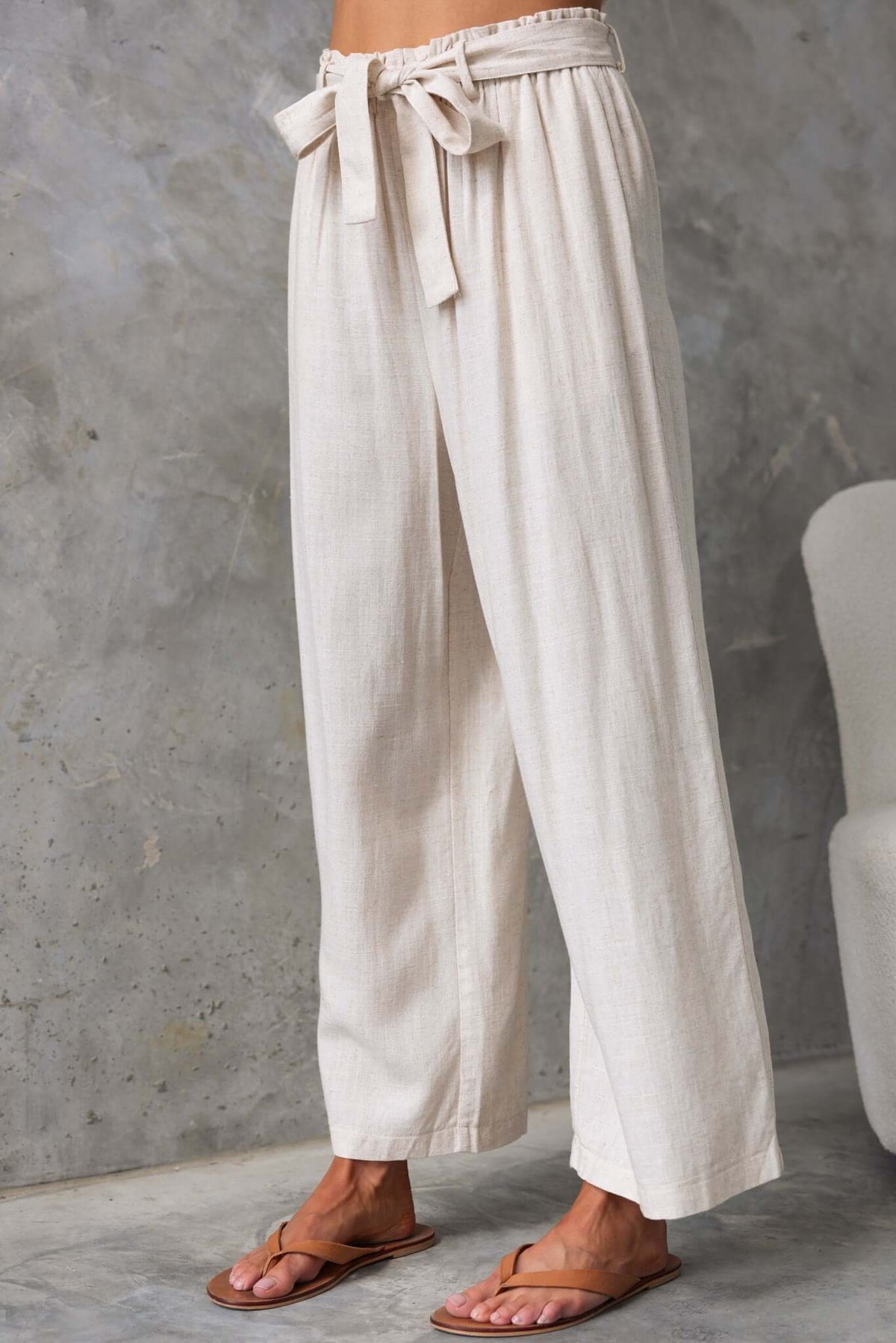 Umali Pants featuring a mid-high waist, elastic waistband, removable tie, and a linen look, perfect for summer wear.