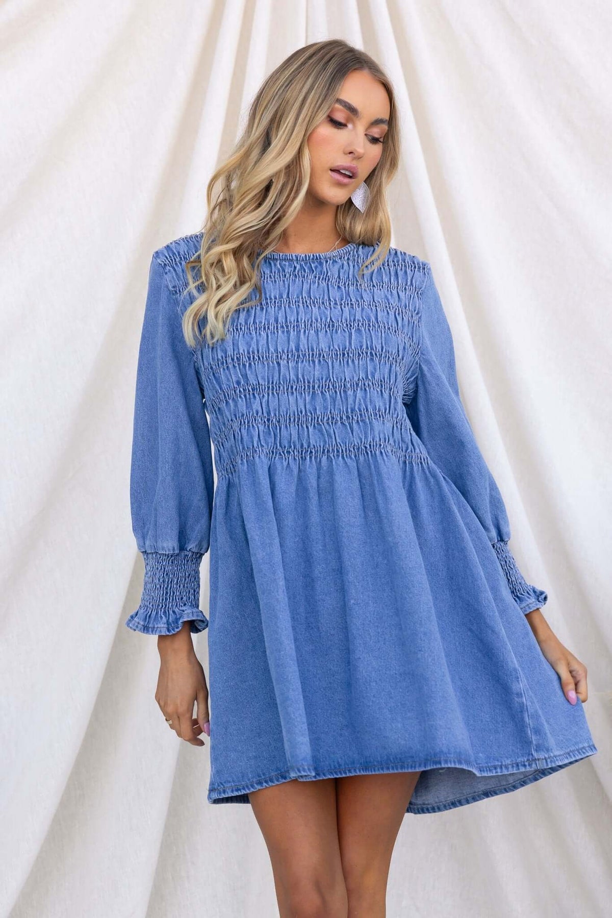 Tulsa Denim Dress featuring smocked bodice, relaxed fit, and balloon sleeves in light blue denim.