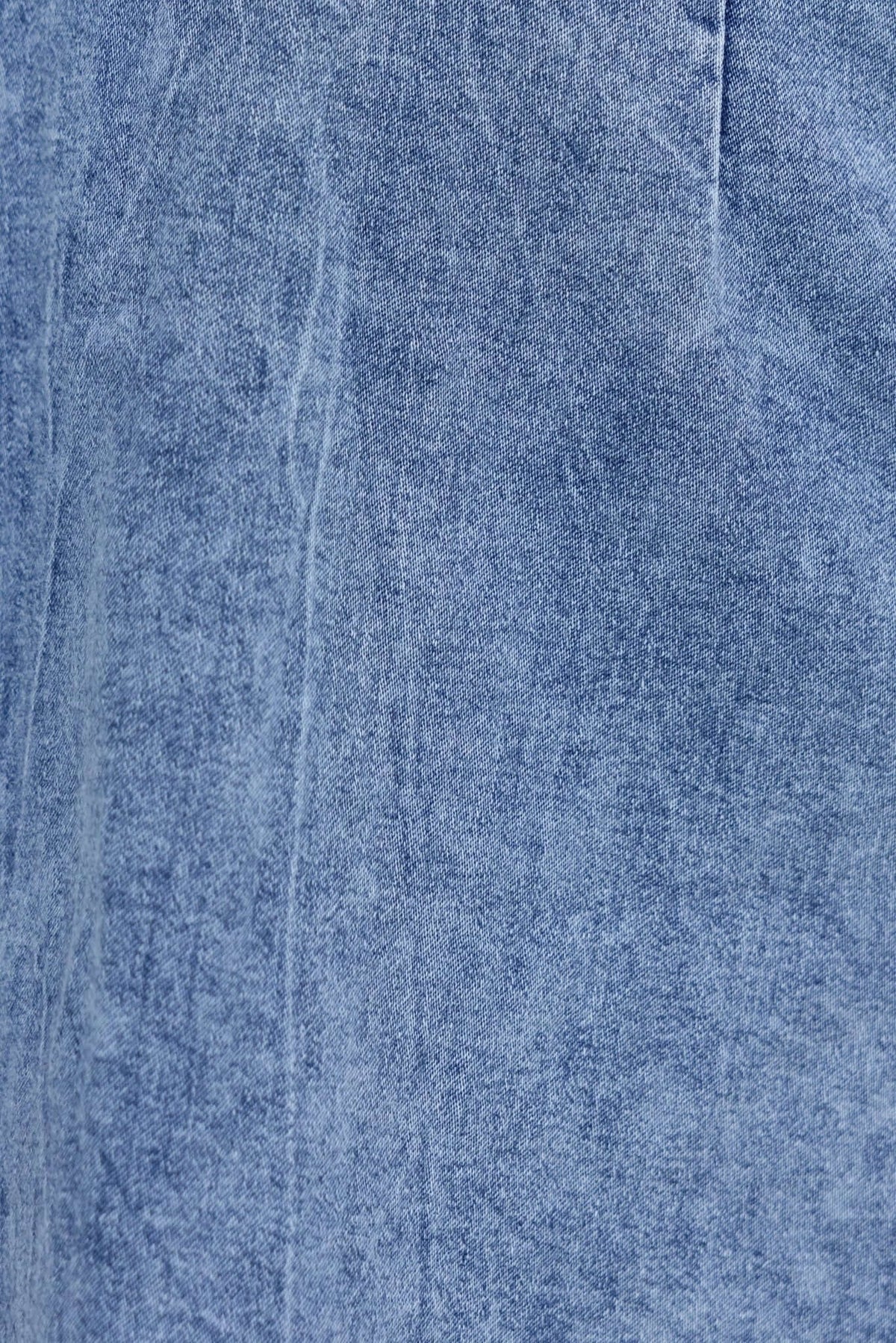 Close-up of soft blue denim fabric texture showcasing the material of the Kairos Denim Dress.