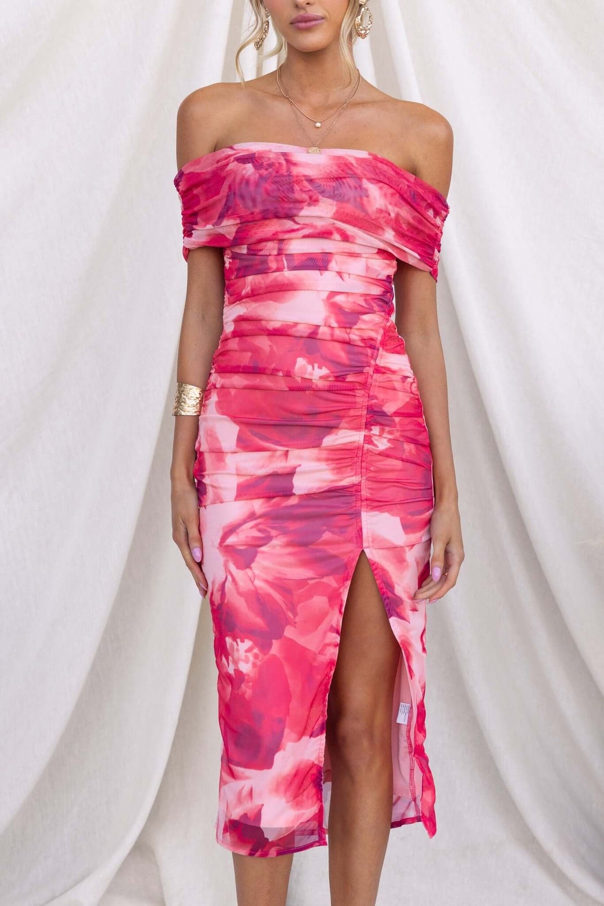 Talinga Midi Dress featuring off-shoulder neckline, asymmetric hem, and vibrant pink floral design, perfect for summer occasions.