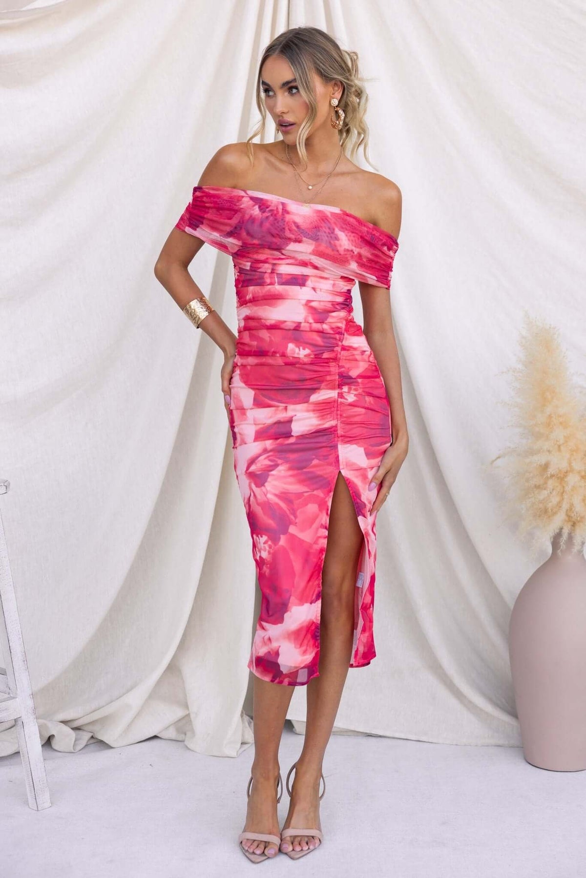 Talinga Midi Dress with off-shoulder neckline and asymmetric hemline in pink and red hues, perfect for summer wear.