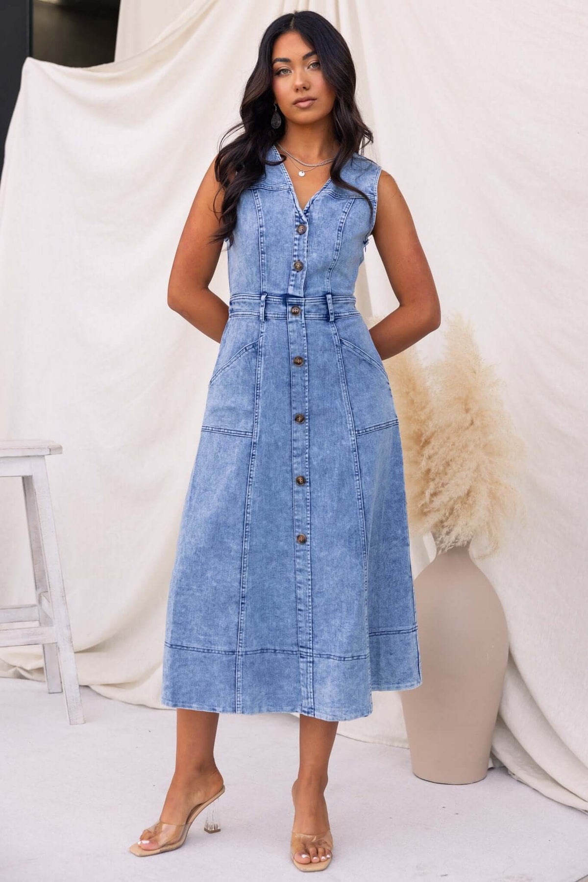 Kerrie Denim Midi Dress featuring a V-neckline, buttons at bust, and a belted waist in light blue denim.