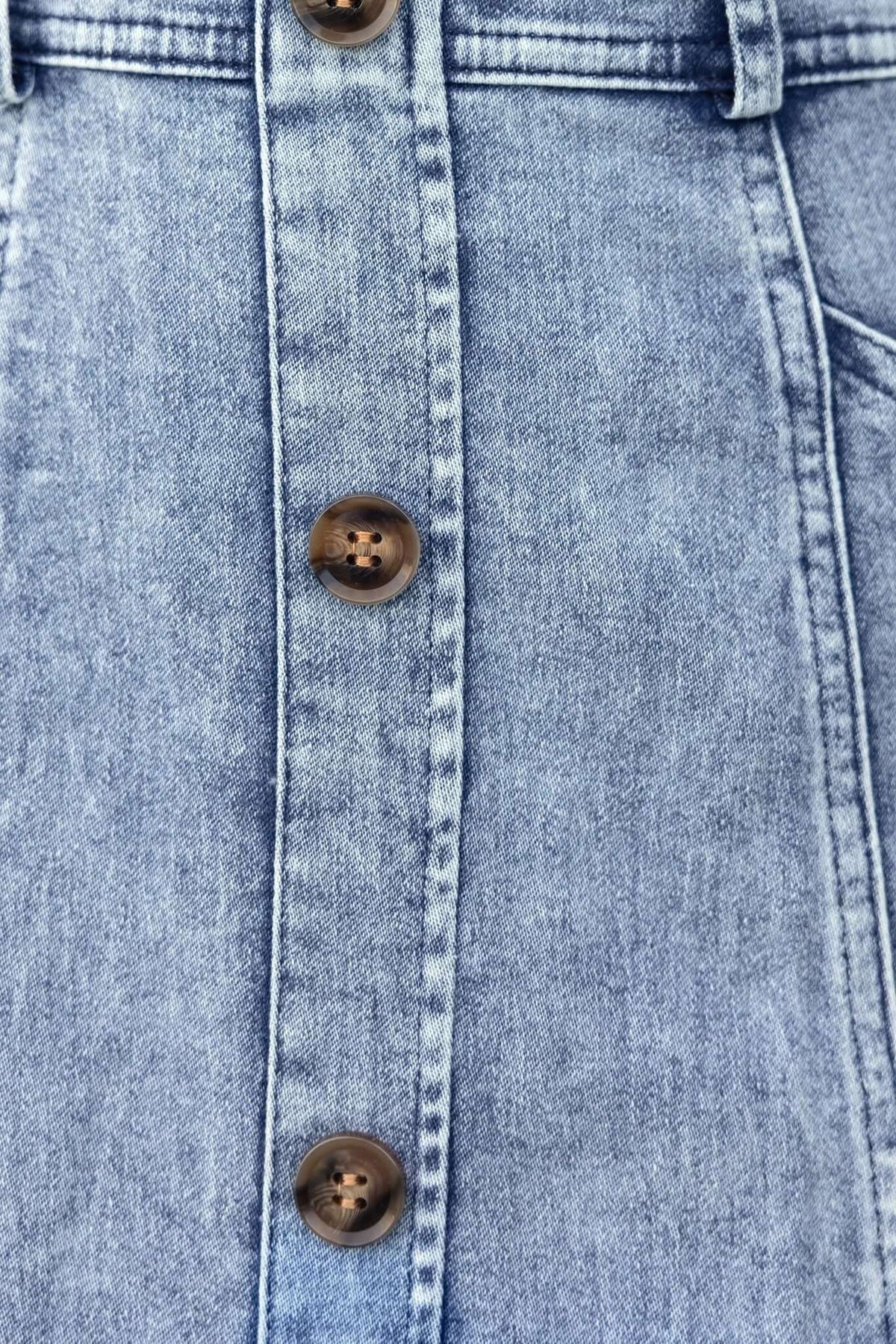 Close-up of Kerrie Denim Midi Dress buttons and fabric, showcasing the stylish design and quality denim.