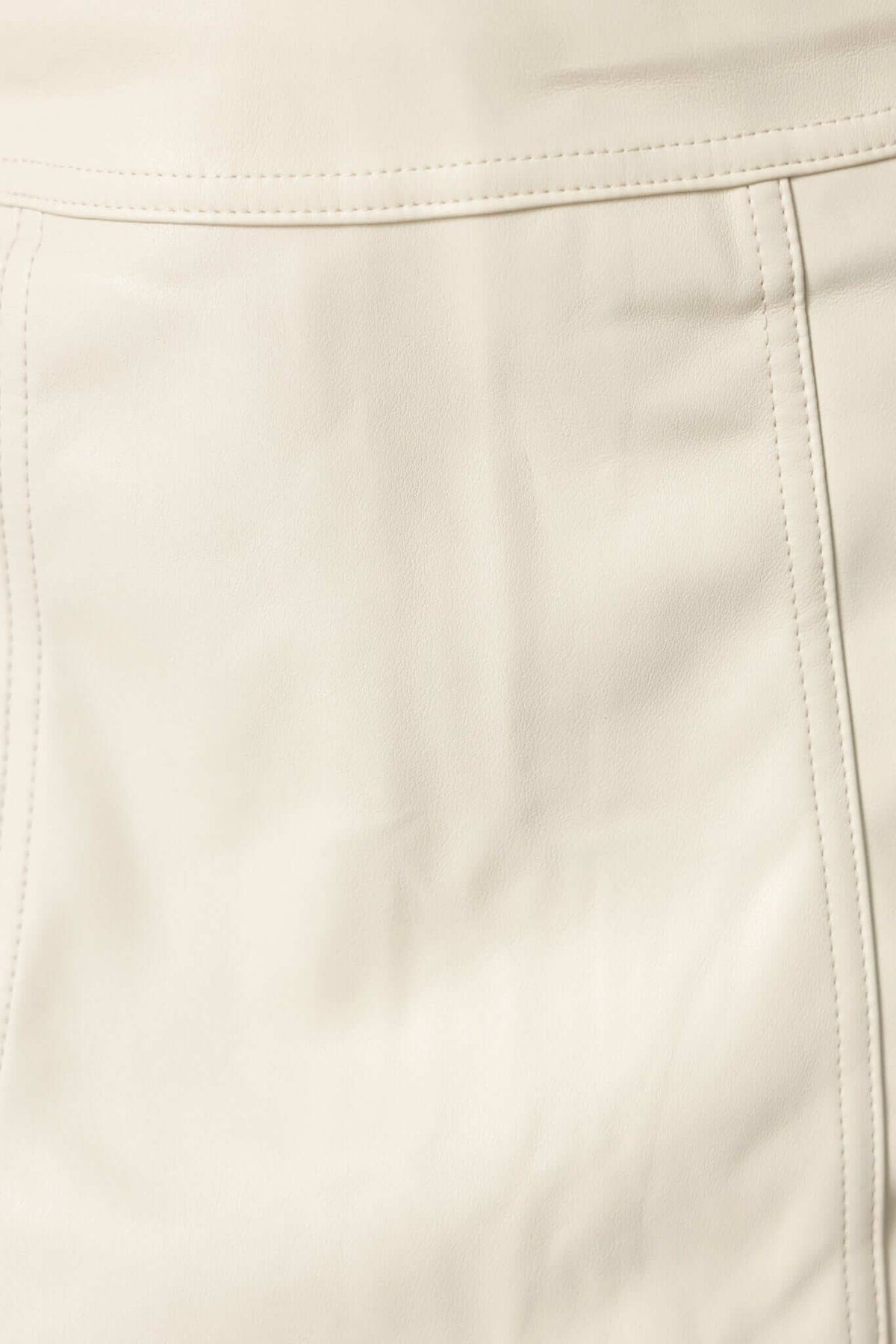 Close-up of Inoe Skirt showcasing its faux leather texture and stitching details.