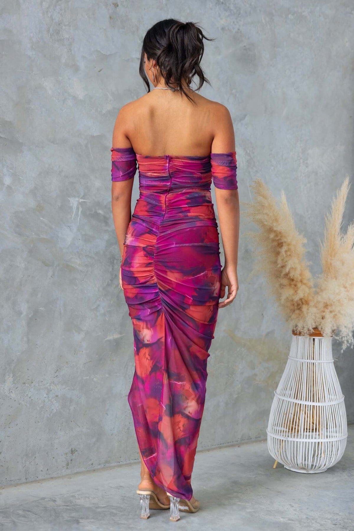 Breslin Maxi Dress in colorful mesh with off-shoulder style, featuring a ruched back and asymmetric hem.
