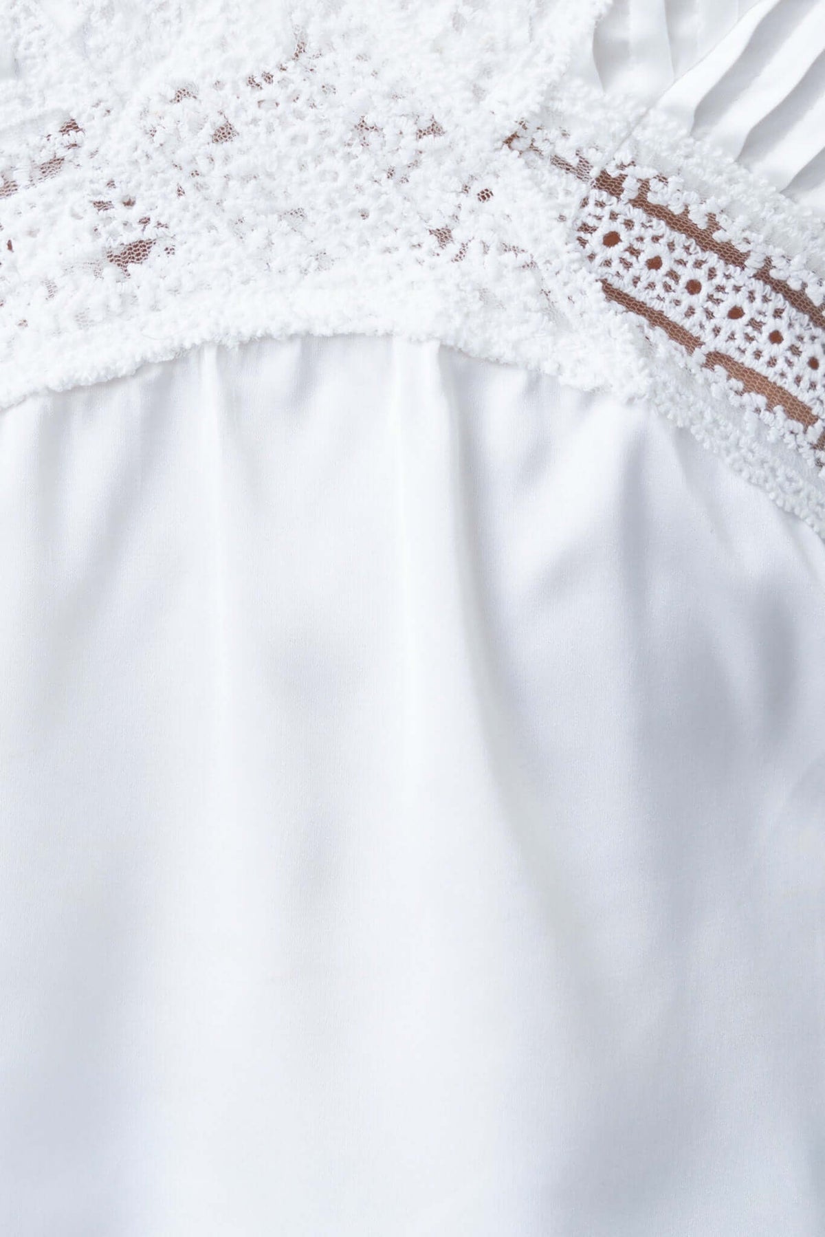 Close-up of Dover Top featuring lace detailing and satin fabric texture, perfect for summer styling.