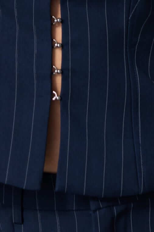 Close-up of navy Renton Pants with button details and pinstripe pattern for summer fashion.