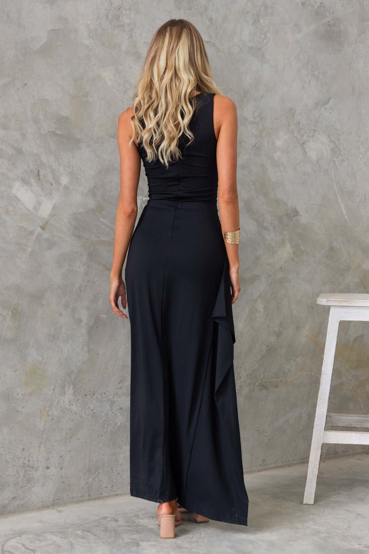 Back view of a black Glory Maxi Dress featuring a square neckline and ruffle at the side, perfect for summer wear.