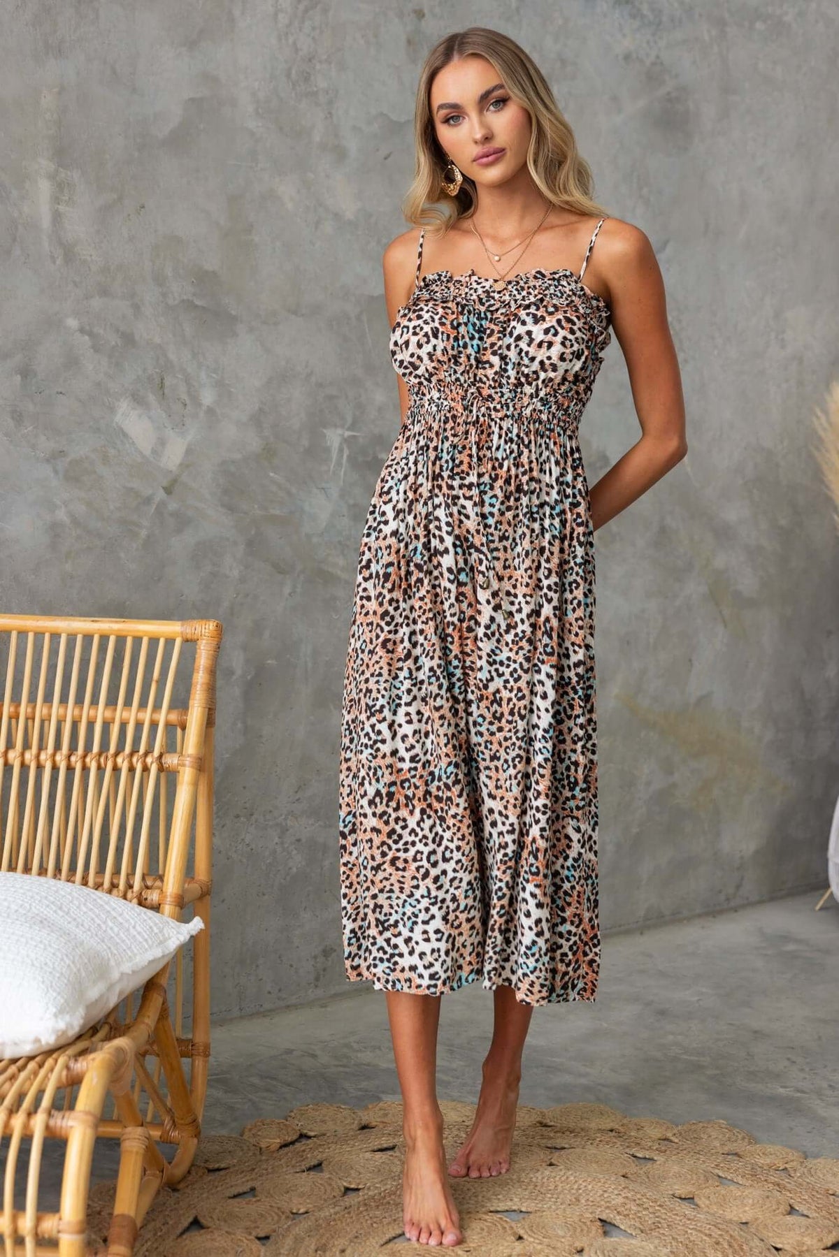 Abeni Jumpsuit featuring adjustable straps, elastic waist, and a stylish animal print for summer wear.