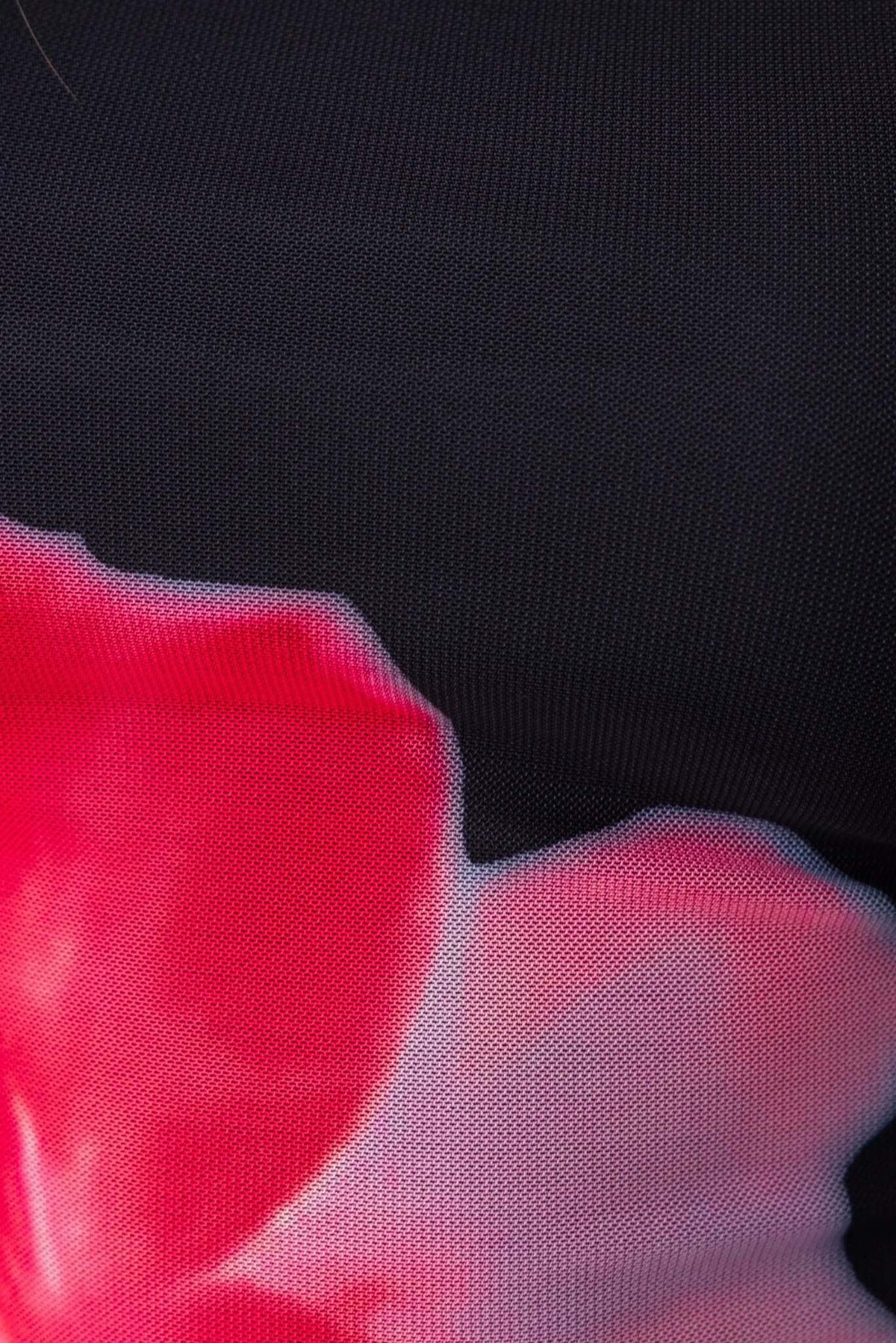 Close-up of floral pattern on black mesh fabric, showcasing vibrant pink details for Lyra Maxi Dress.