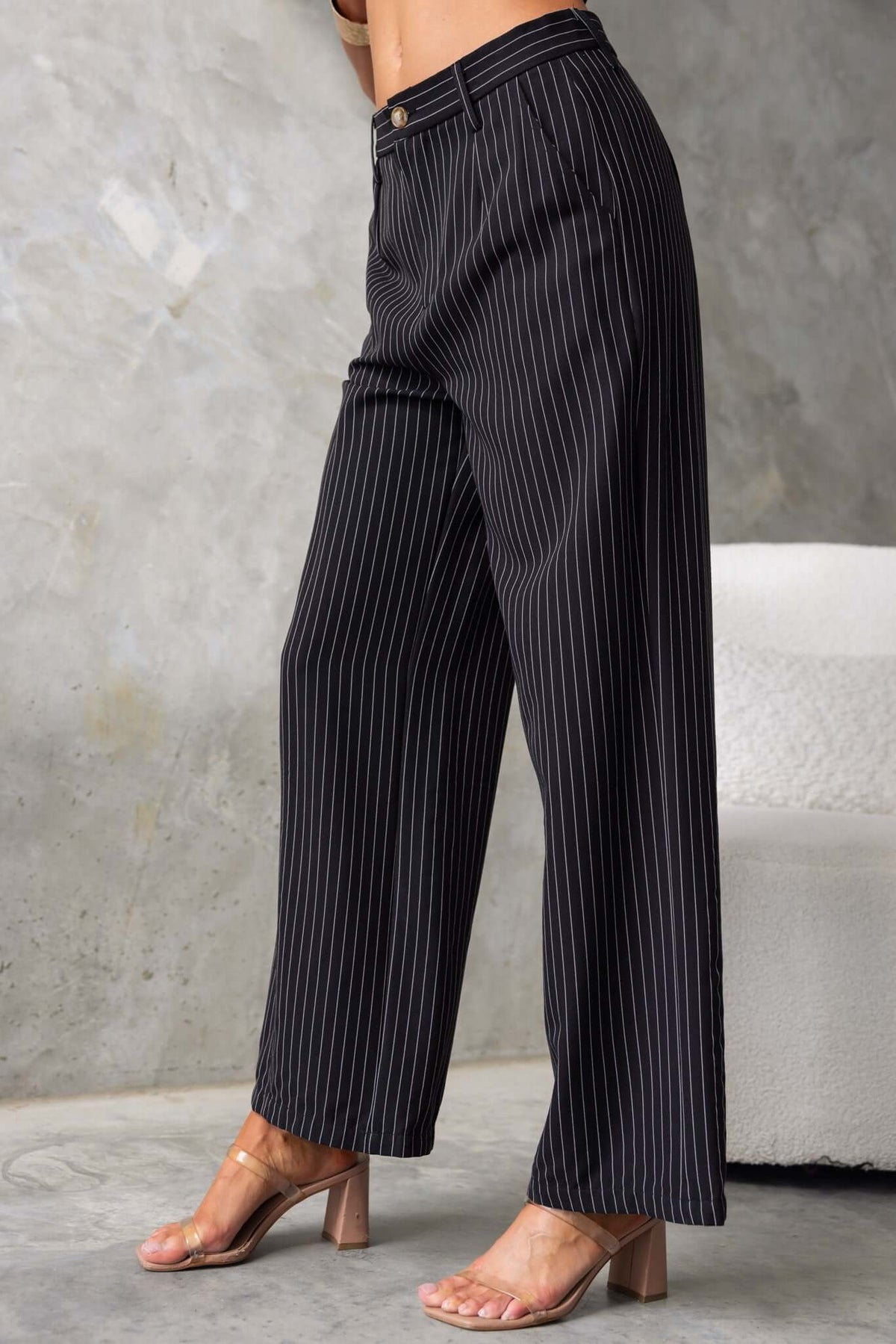 Black striped mid-high waist pants with pockets, perfect for summer fashion.