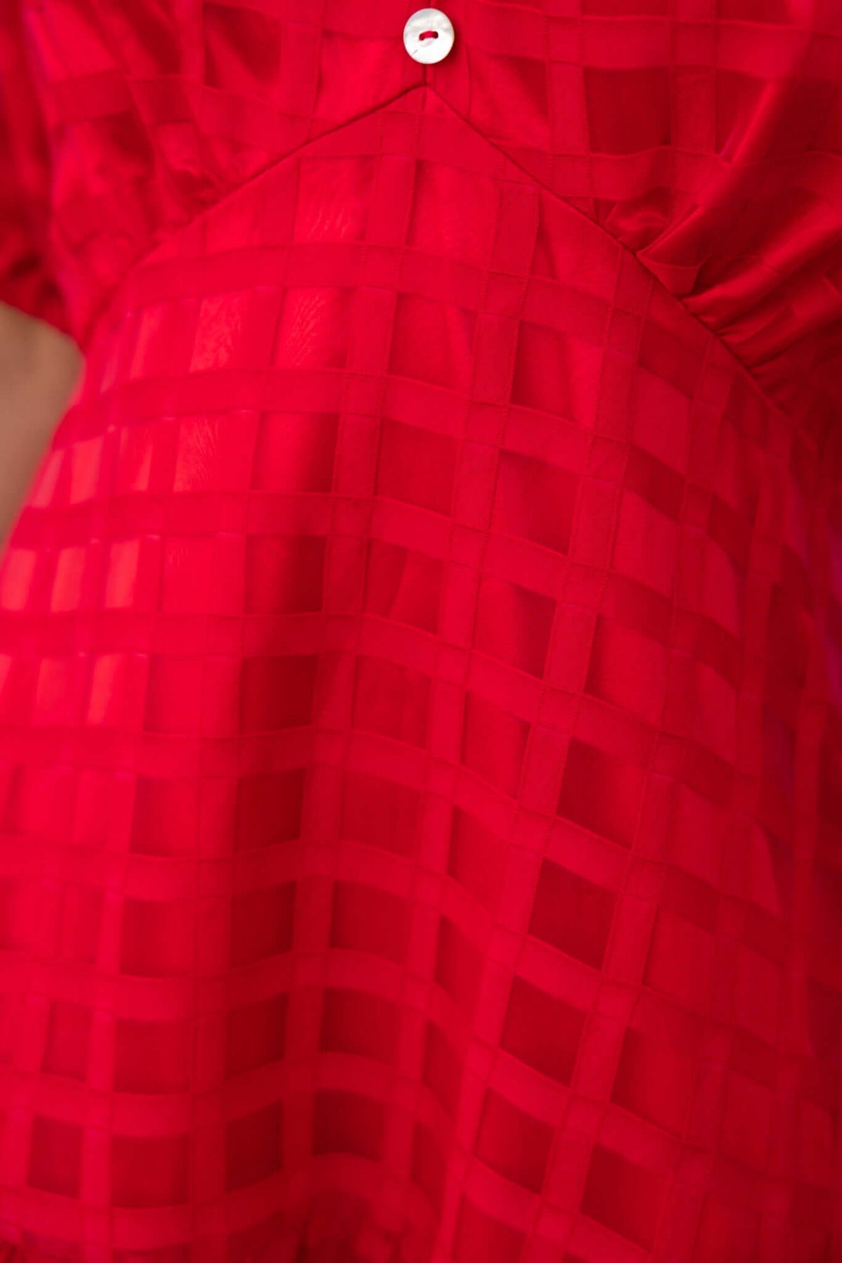 Detailed view of the red Barker Midi Dress featuring a faux button front and textured checkered pattern.
