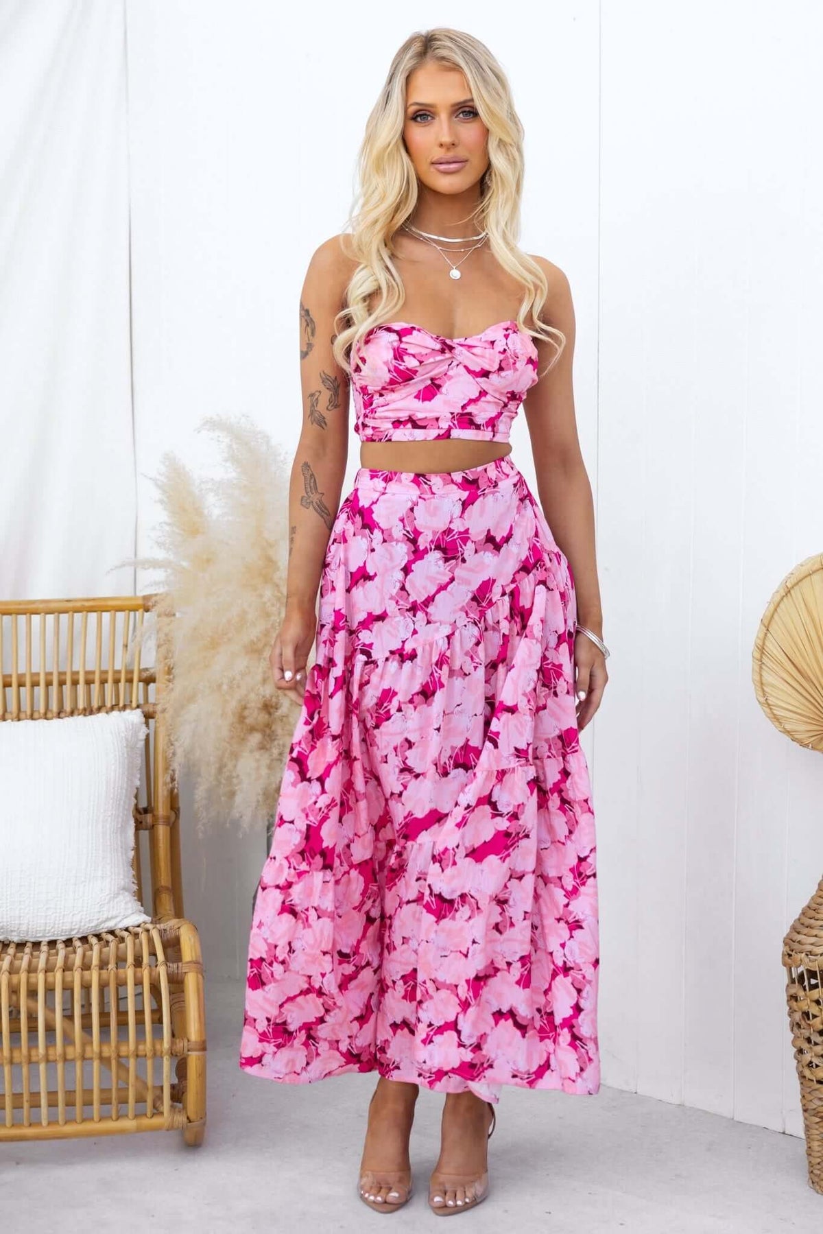 Model wearing Peachy Days Top with matching skirt, featuring pink floral print, styled with boho accessories.
