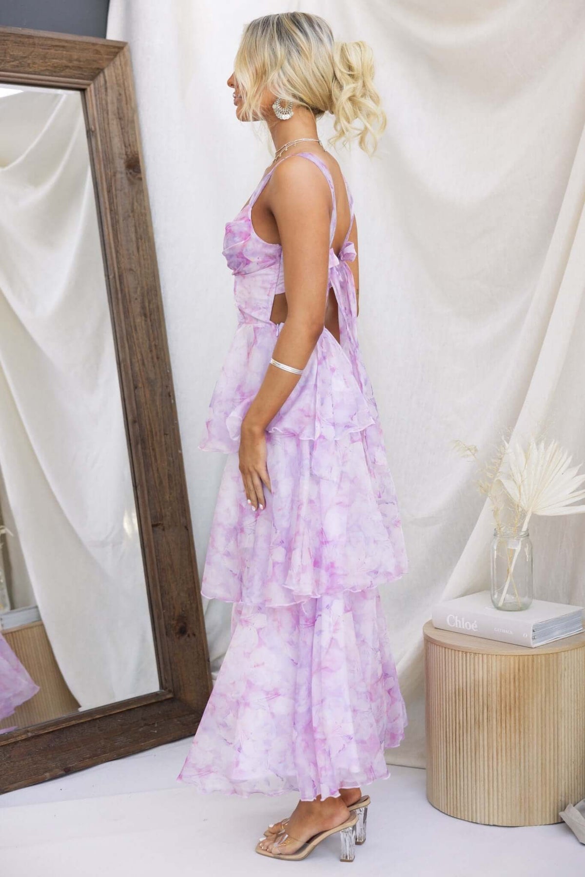Bennett Ave Maxi Dress in light purple with tiered frills, showcased from the side view, featuring a tie-back and lightweight design.