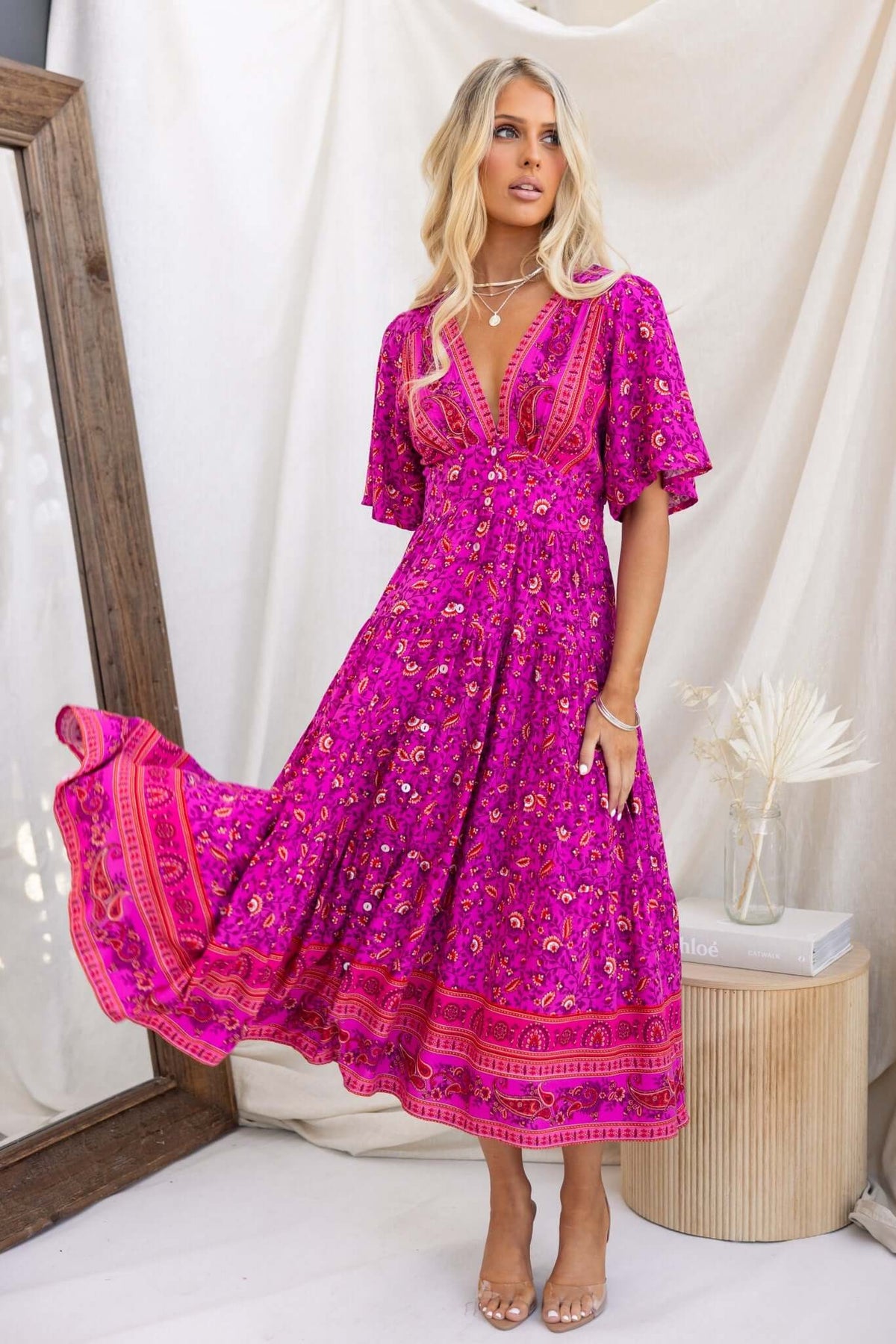 Hope filled Midi Dress in vibrant pink with floral patterns, featuring a button-down front and flowing skirt.