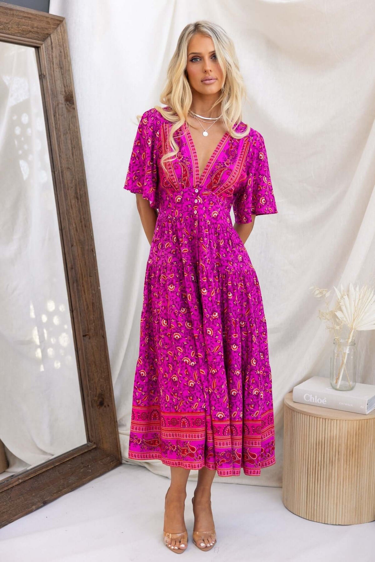 Hope filled Midi Dress in vibrant pink with floral patterns, featuring button front and shirred waist, perfect for stylish summer looks.