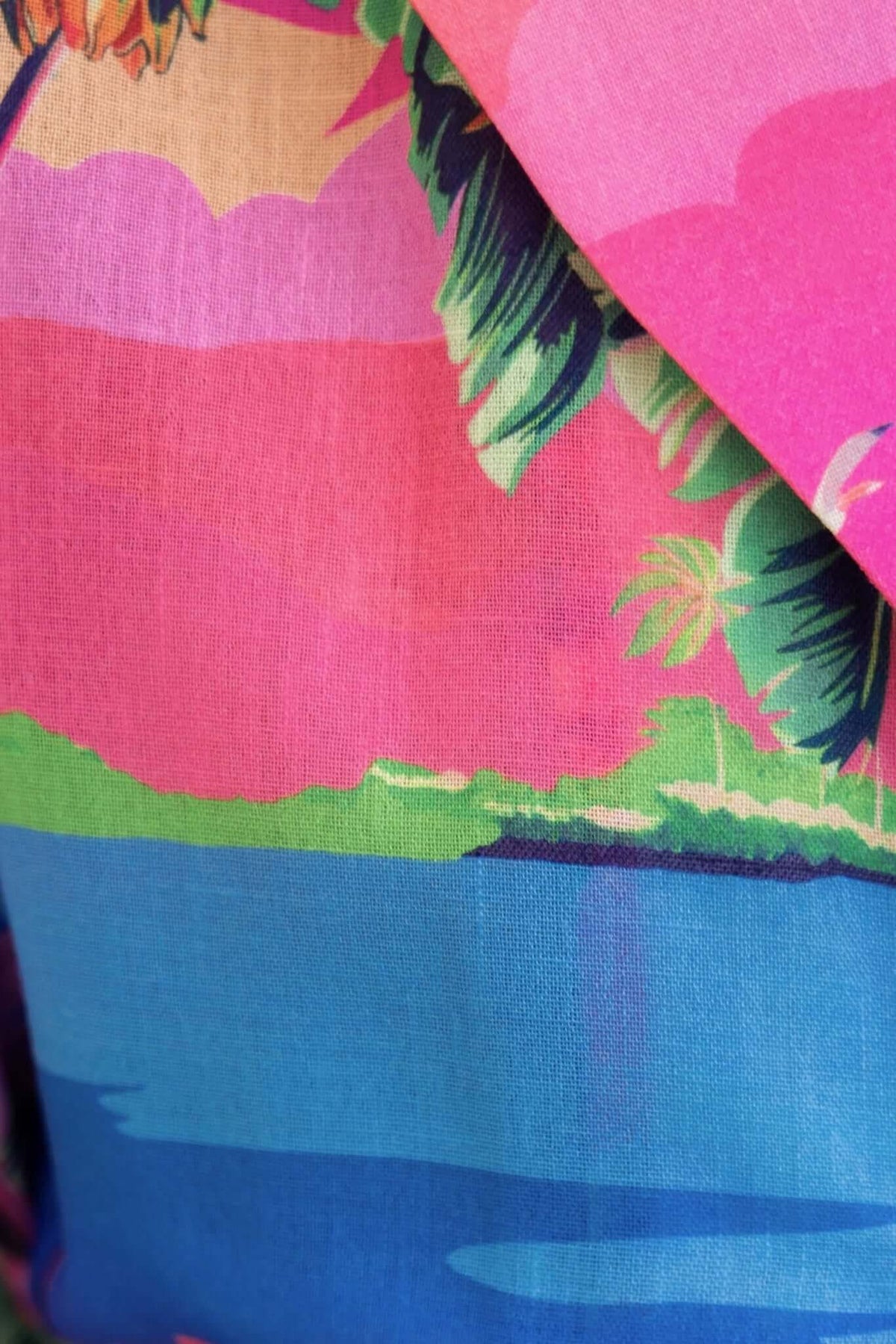 Colorful tropical print fabric featuring vibrant pink and blue hues, ideal for a Holiday Mode Playsuit.