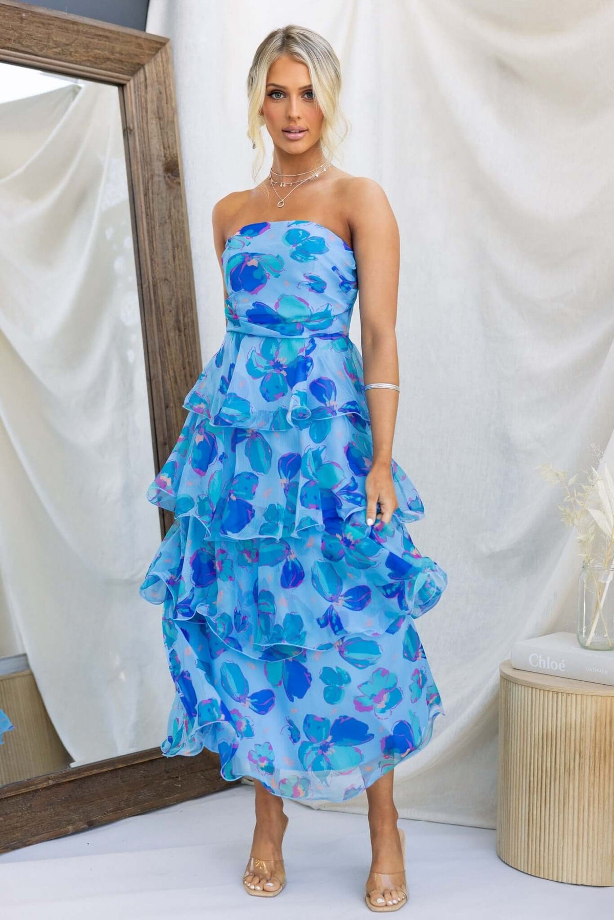 Terrace Maxi Dress in blue floral print, featuring a strapless design and ruffled layers, perfect for summer outings.