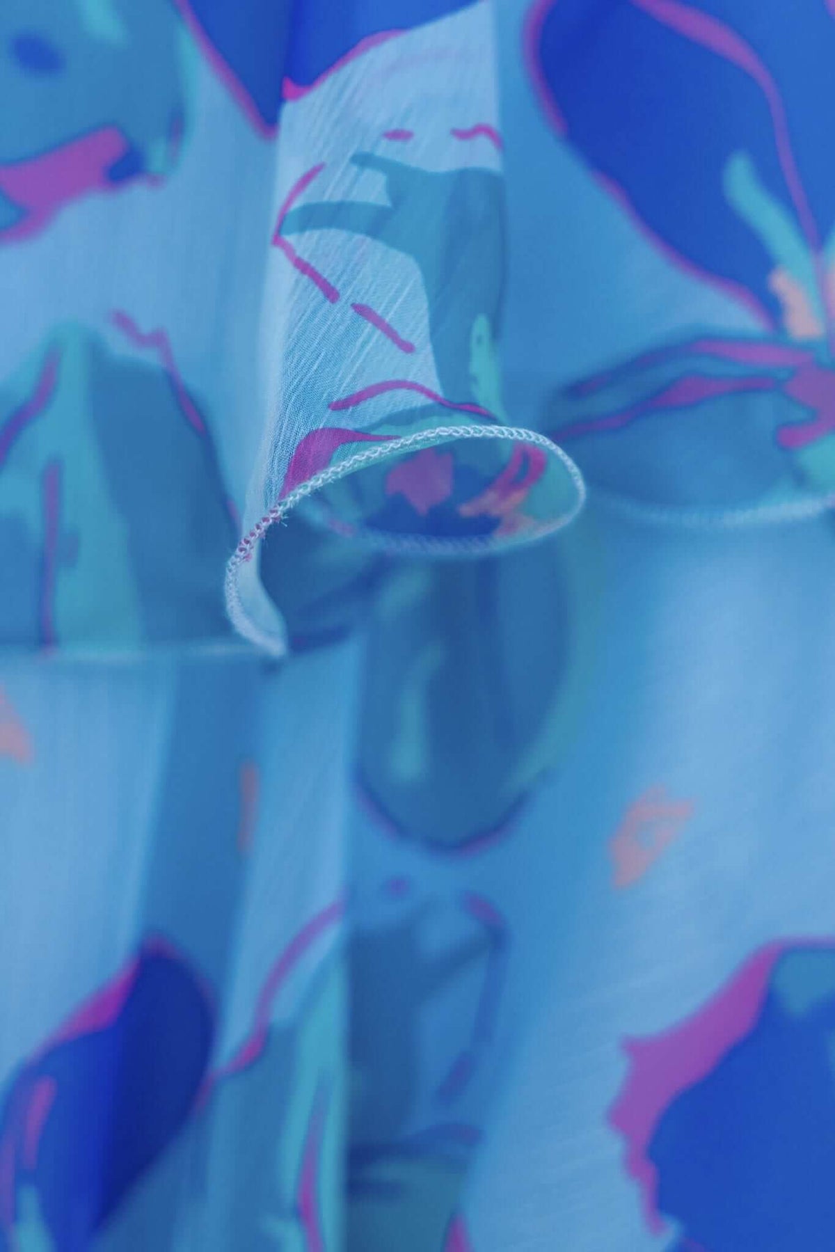 Close-up of a blue and pink floral pattern fabric for the Terrace Maxi Dress, showcasing its lightweight, flowy texture.