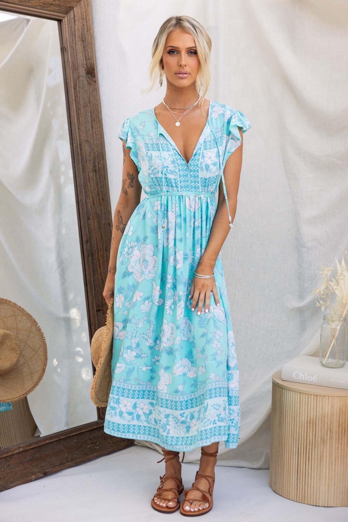 Coastal Breeze Maxi Dress featuring a floral print, relaxed fit, and tie details, modeled with sandals.