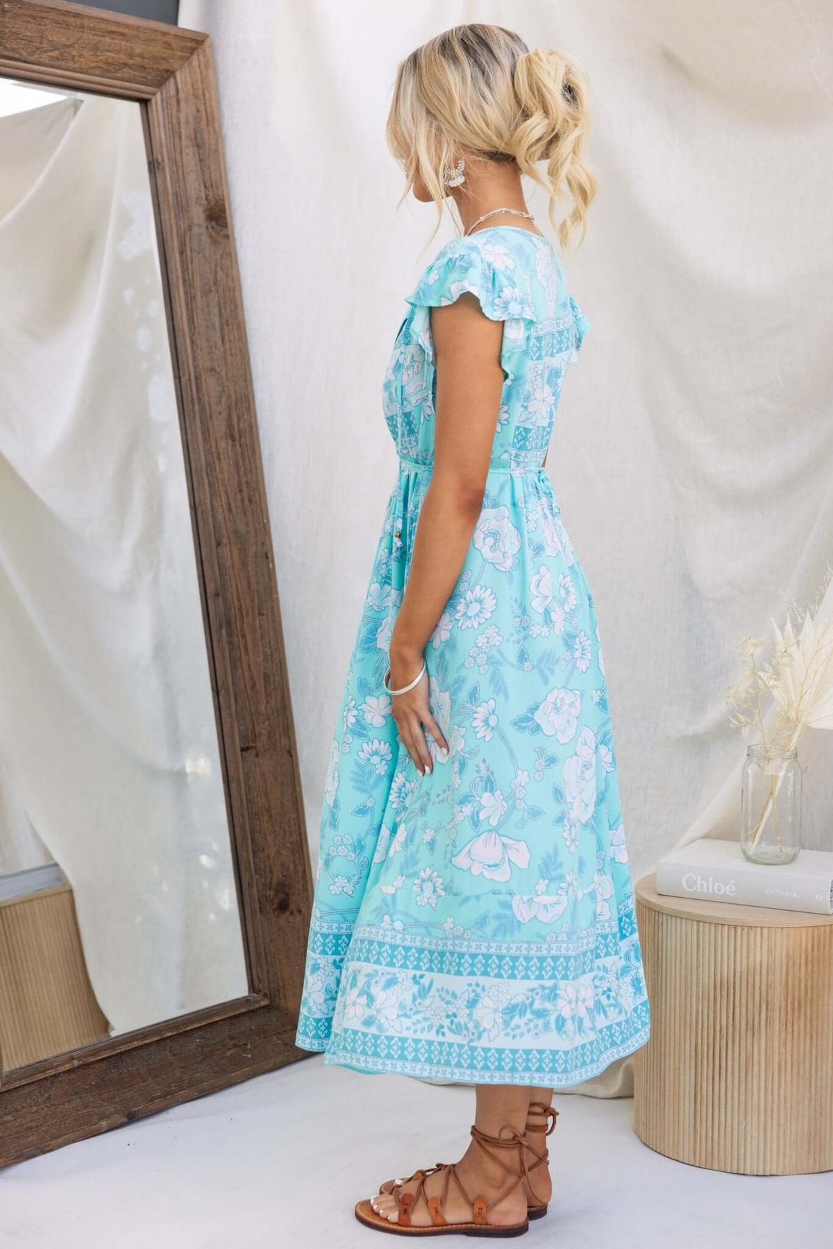 Model in a coastal breeze maxi dress with side pockets, showing a relaxed fit and floral pattern in light blue.