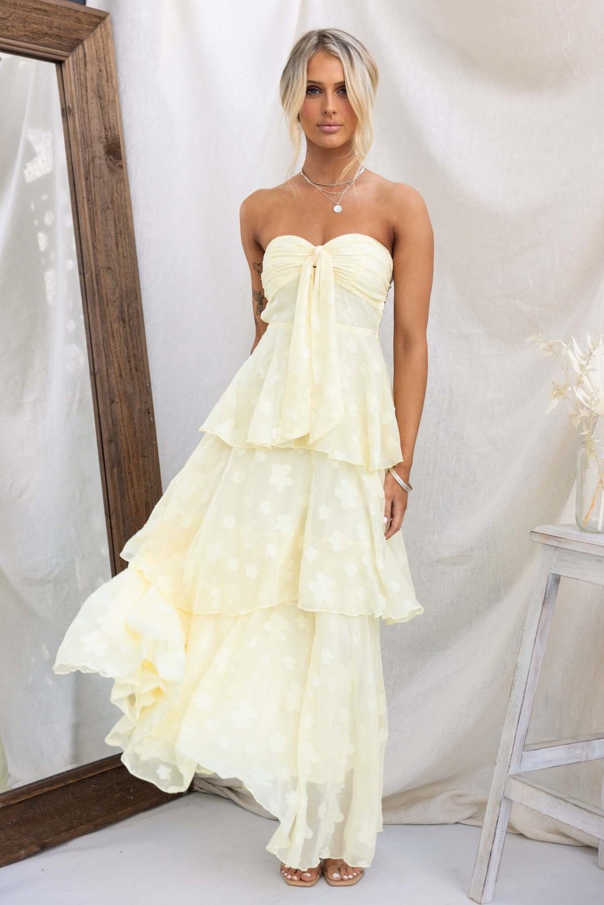 Soft Whispers Maxi Dress in soft yellow with tiered ruffles, removable tie, and elastic back for a flowy summer look.