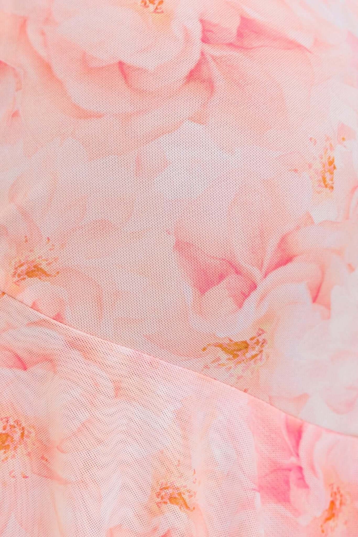 Close-up of pink floral mesh fabric with a soft texture, perfect for a Vessy maxi dress.