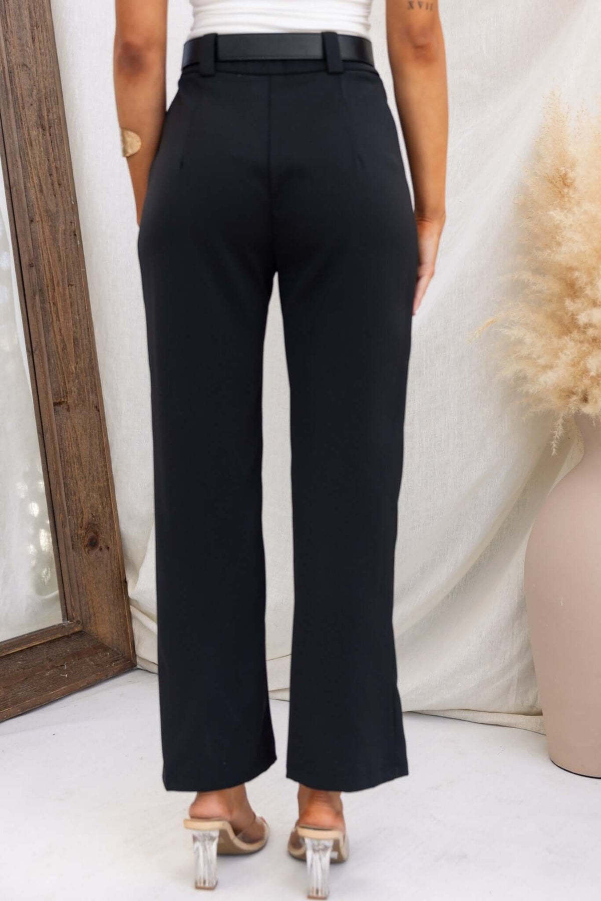 Back view of black Columbus Pants featuring a mid-high waist fit, non-stretch material, and no belt.