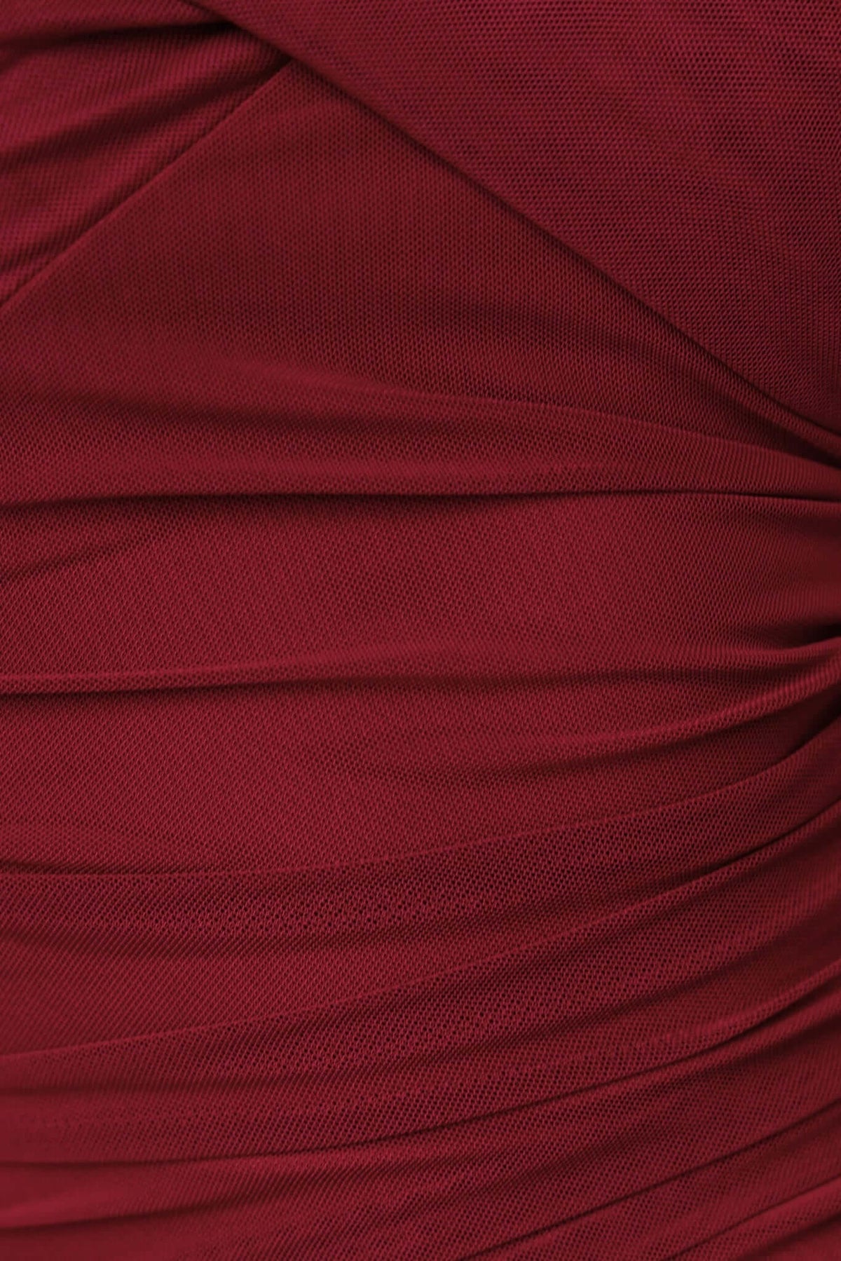 Close-up of ruched burgundy mesh fabric from the Nicho Mini Dress, showcasing texture and stretch detail.