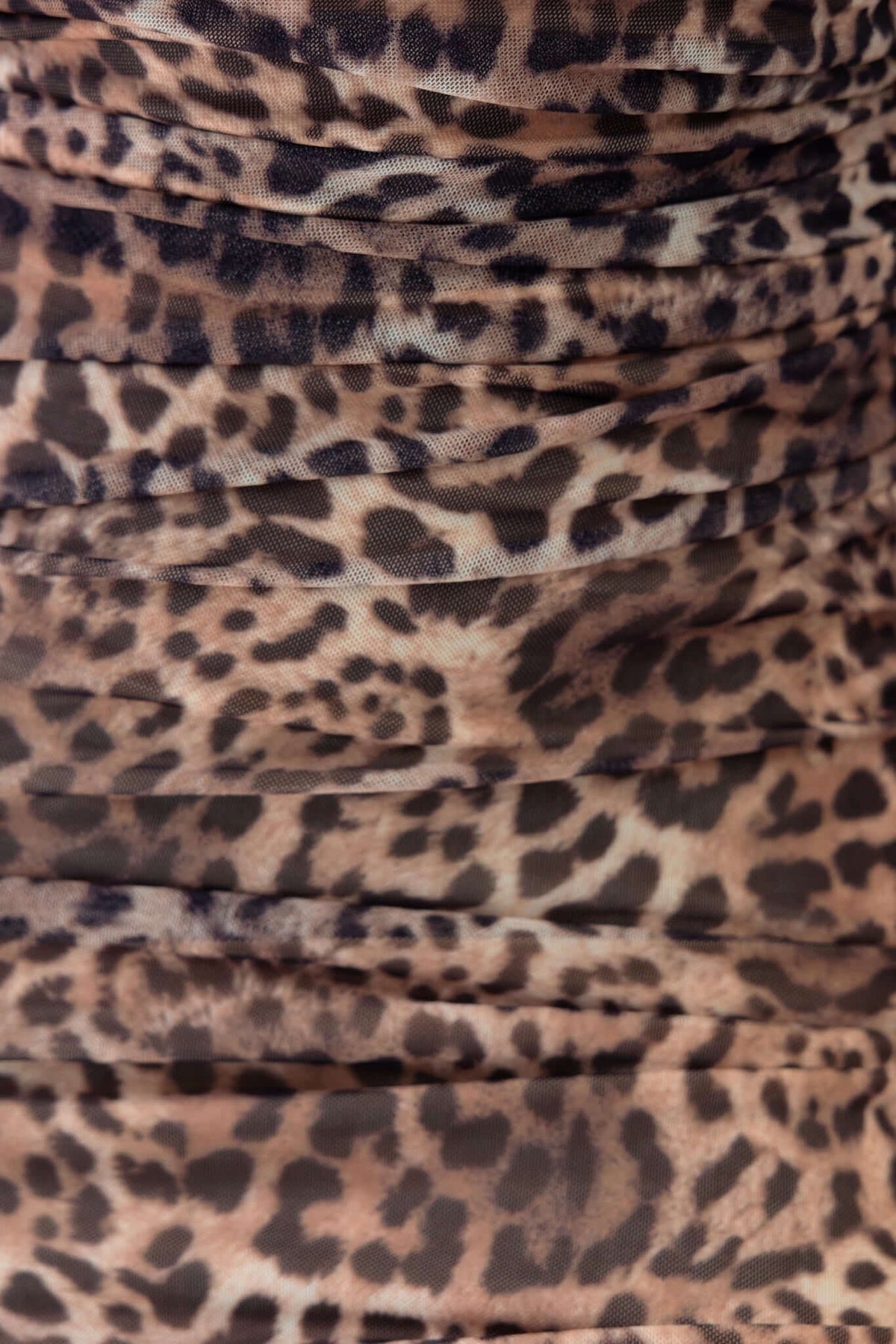 Close-up of leopard print fabric showcasing soft, ruched design, ideal for trendy outfit styling.