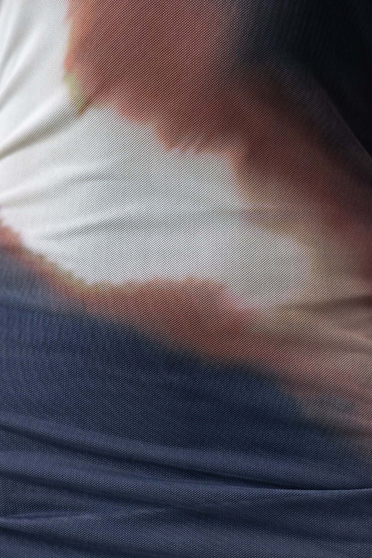 Close-up of the Dusk Maxi Dress fabric featuring a blend of warm colors in a mesh overlay texture.