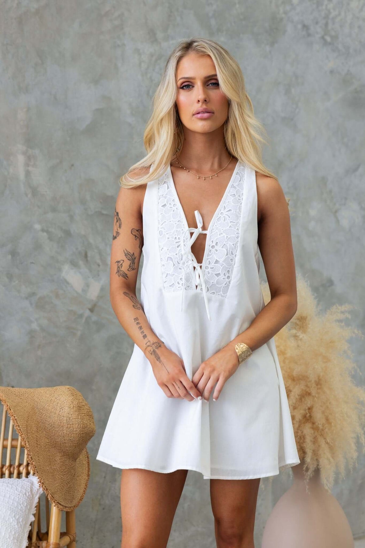 Model wearing a Sandy Day Dress with a tie front detail, featuring a cotton feel and A-line style, perfect for summer.