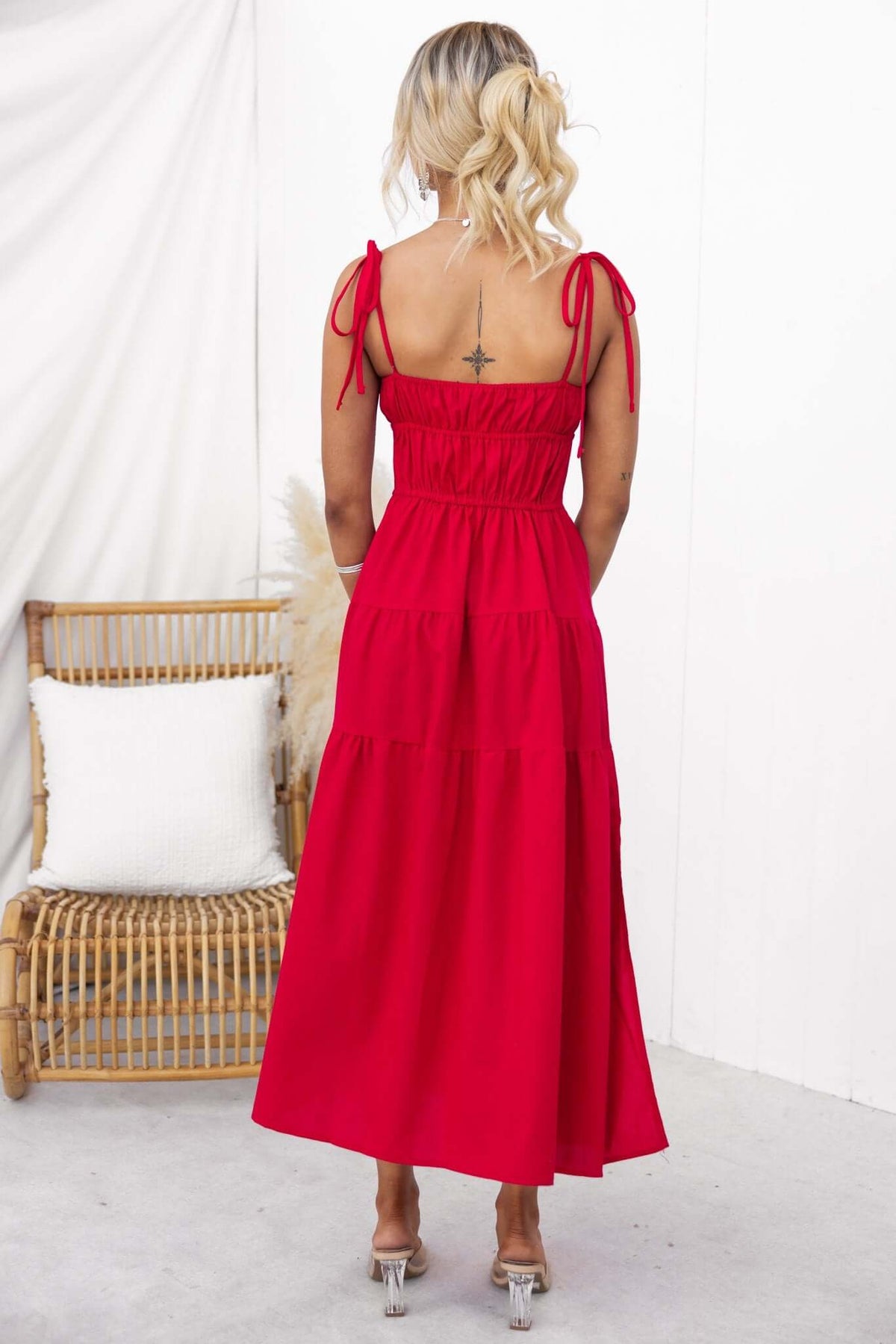 Back view of Gresham Maxi Dress in red, featuring thin tie straps, elastic back, and tiered skirt.
