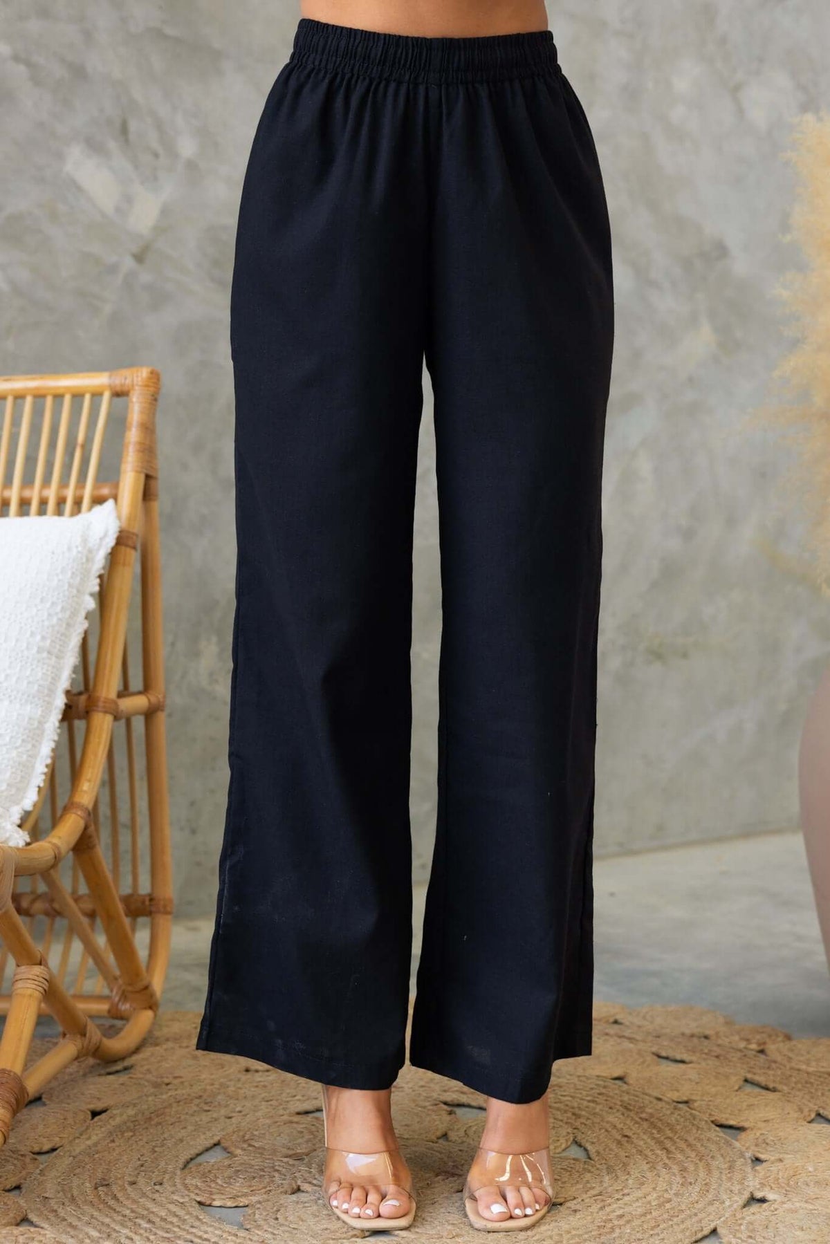 Payson Pants in black, featuring an elastic waist and lined design, displayed with a minimalist background.