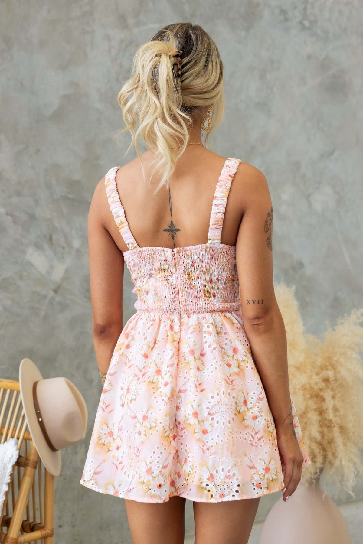 Back view of the Sunshine Goodness Mini Dress with shirred shoulder straps and floral pattern, perfect for summer.