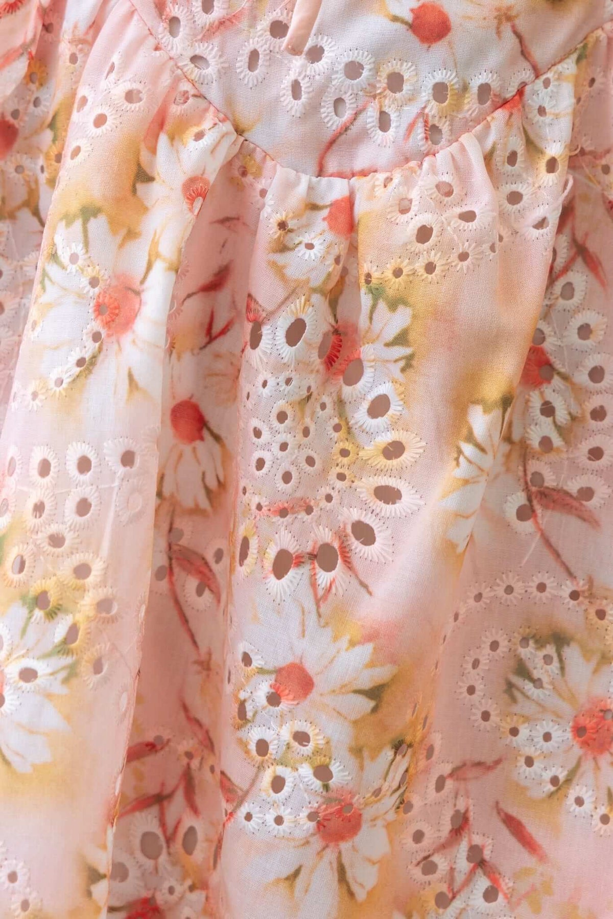 Close-up of the Sunshine Goodness Mini Dress featuring floral pattern and detailed lace trim in soft pastel colors.