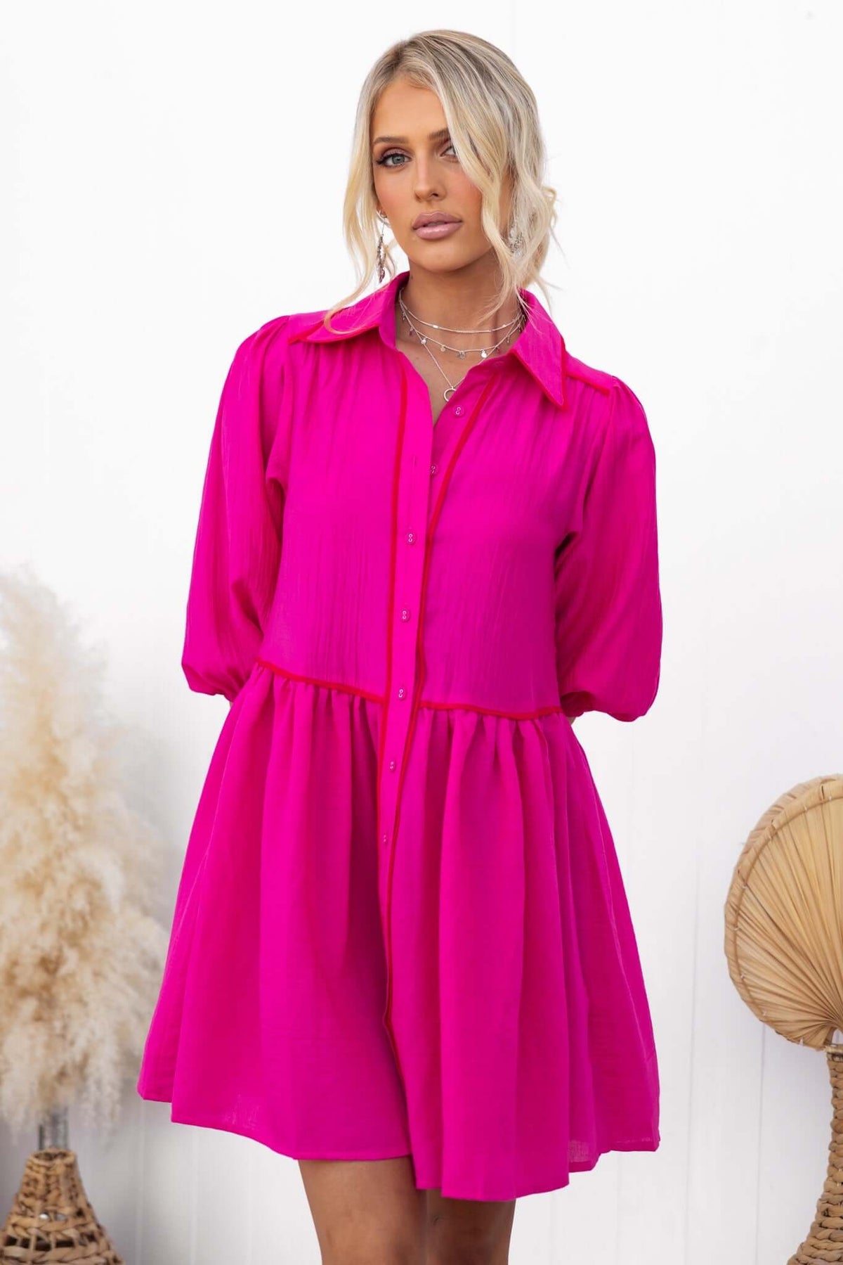Bright pink Sherbet Dress featuring elastic sleeves and button-down front, ideal for a stylish, oversized fit.
