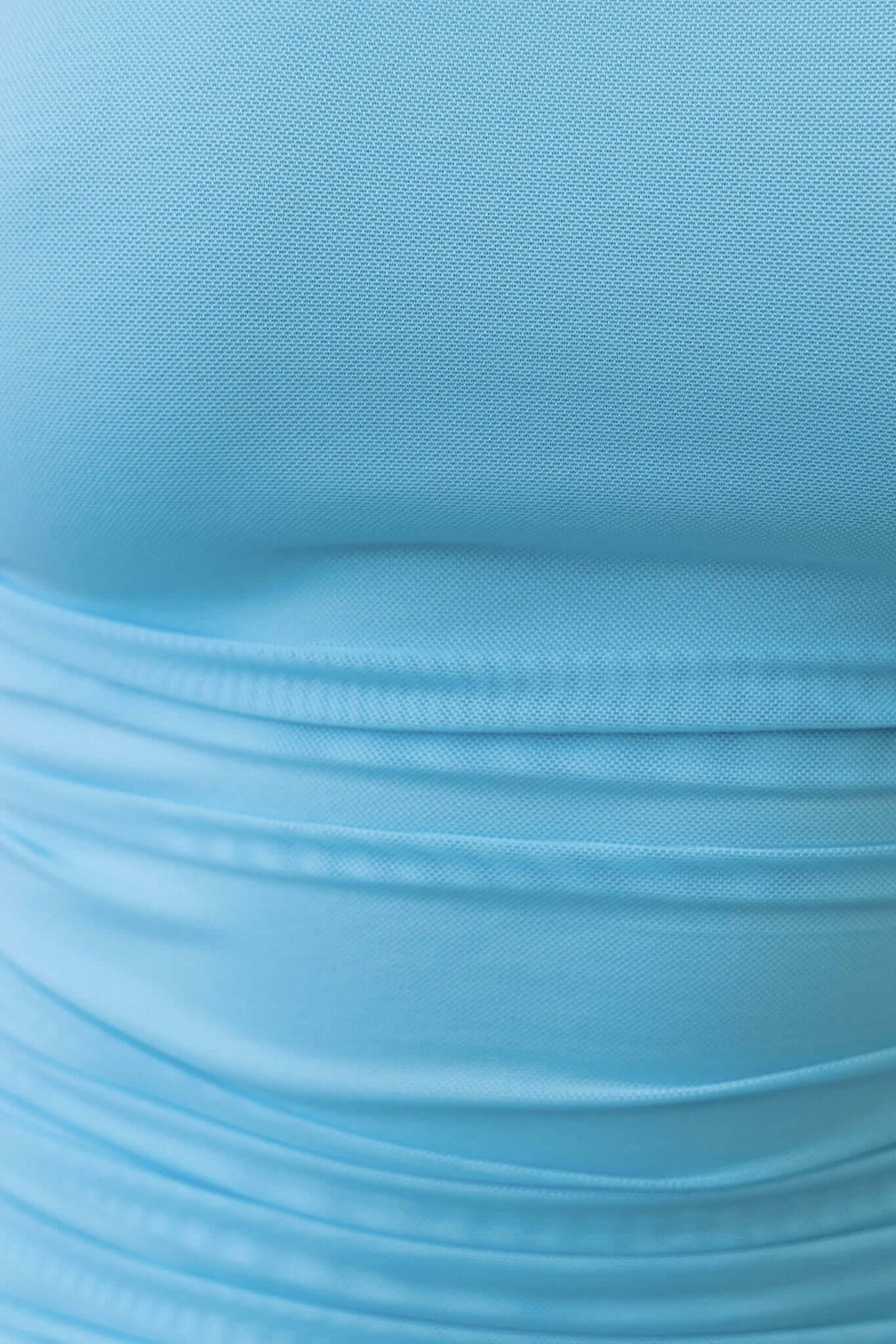 Close-up of light blue mesh fabric showing texture and stretch details for the Fate Maxi Dress.