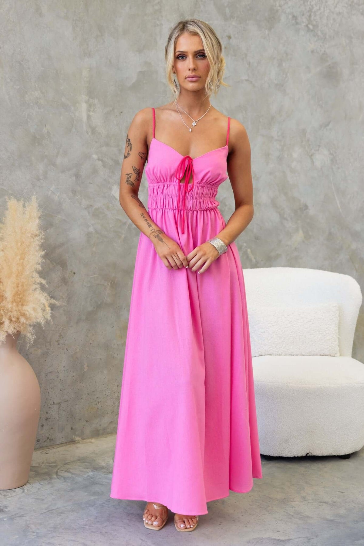 Brooklynn Maxi Dress in pink with adjustable straps and tie detail, featuring a flowy, semi-light material.