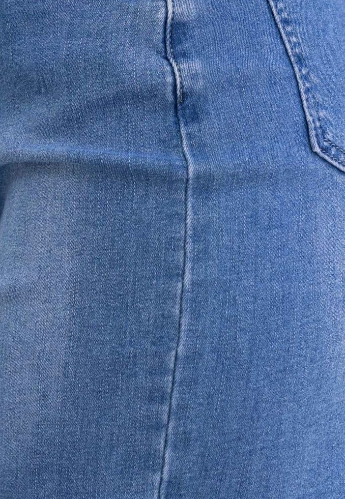 Close-up of Alley Denim Skirt showcasing firm stretch fabric and denim wash.