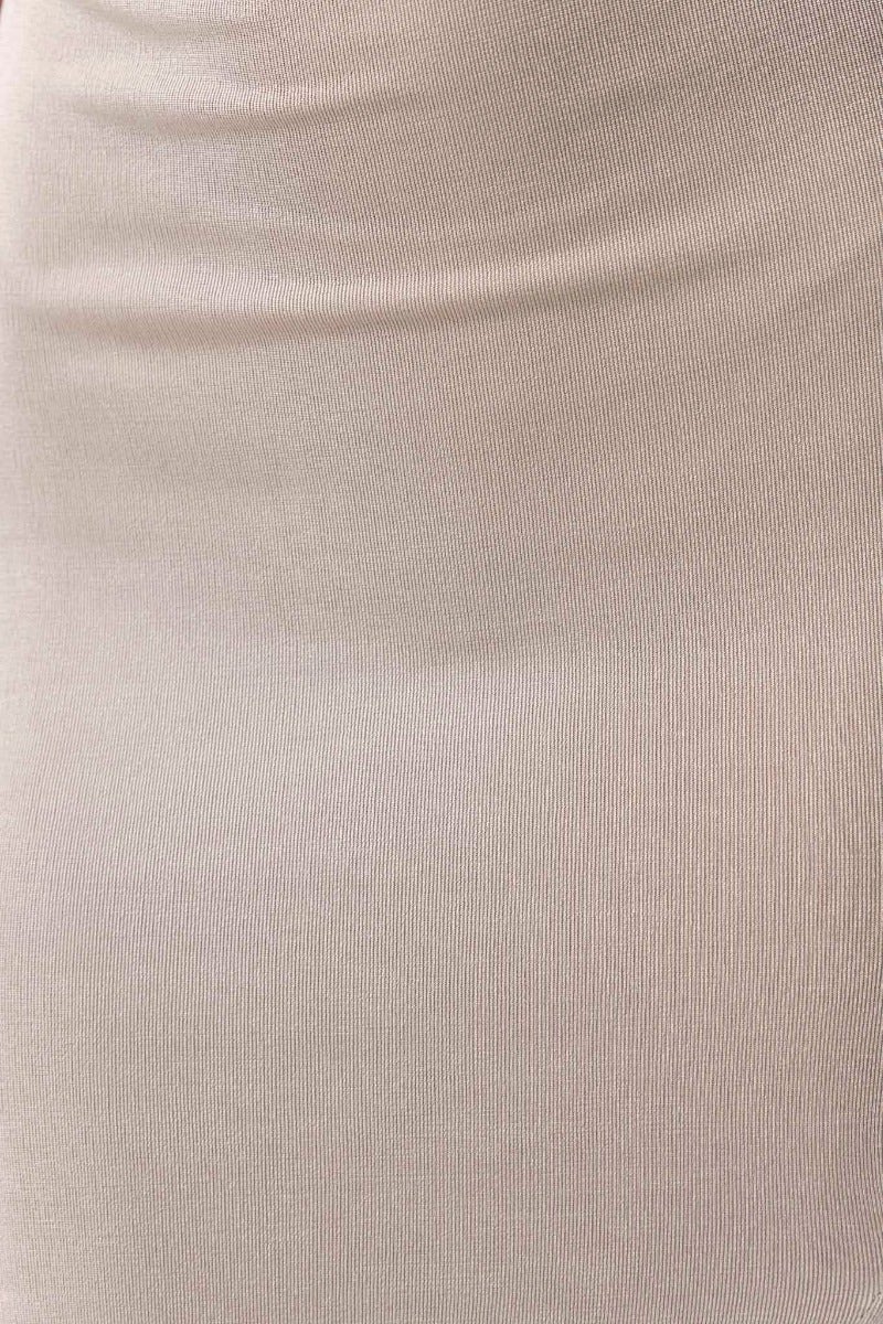 Close-up of stretchy fabric of Qamdo Midi Dress, showcasing the soft beige color and smooth texture.