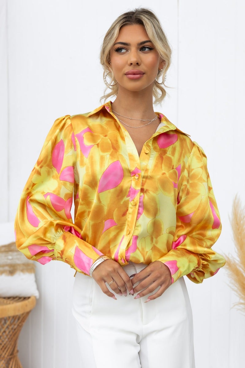 Indianna Top in satin look with vibrant floral print, featuring a button-up front and relaxed fit, styled by model.