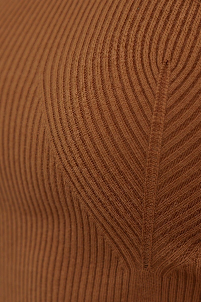Close-up of ribbed knit fabric in warm brown color, showcasing texture and details of the Piah Midi Dress.
