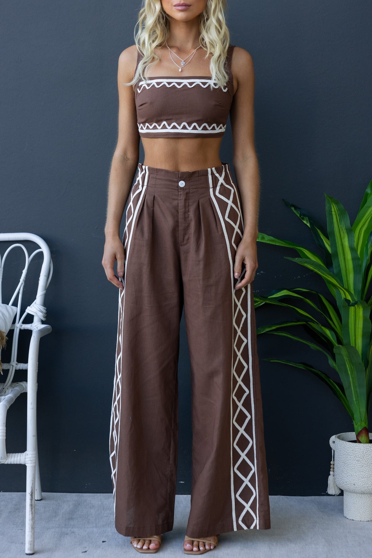 Drisko Set featuring a square neckline crop top with adjustable straps and wide-leg pants with a mid-high waist fit.